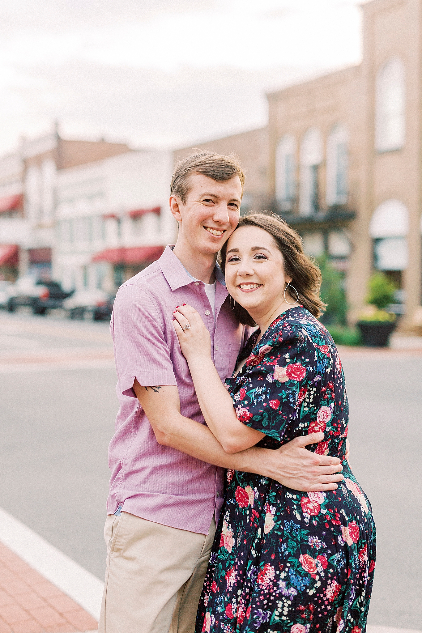 married couple hugs along street in Downtown Mooresville