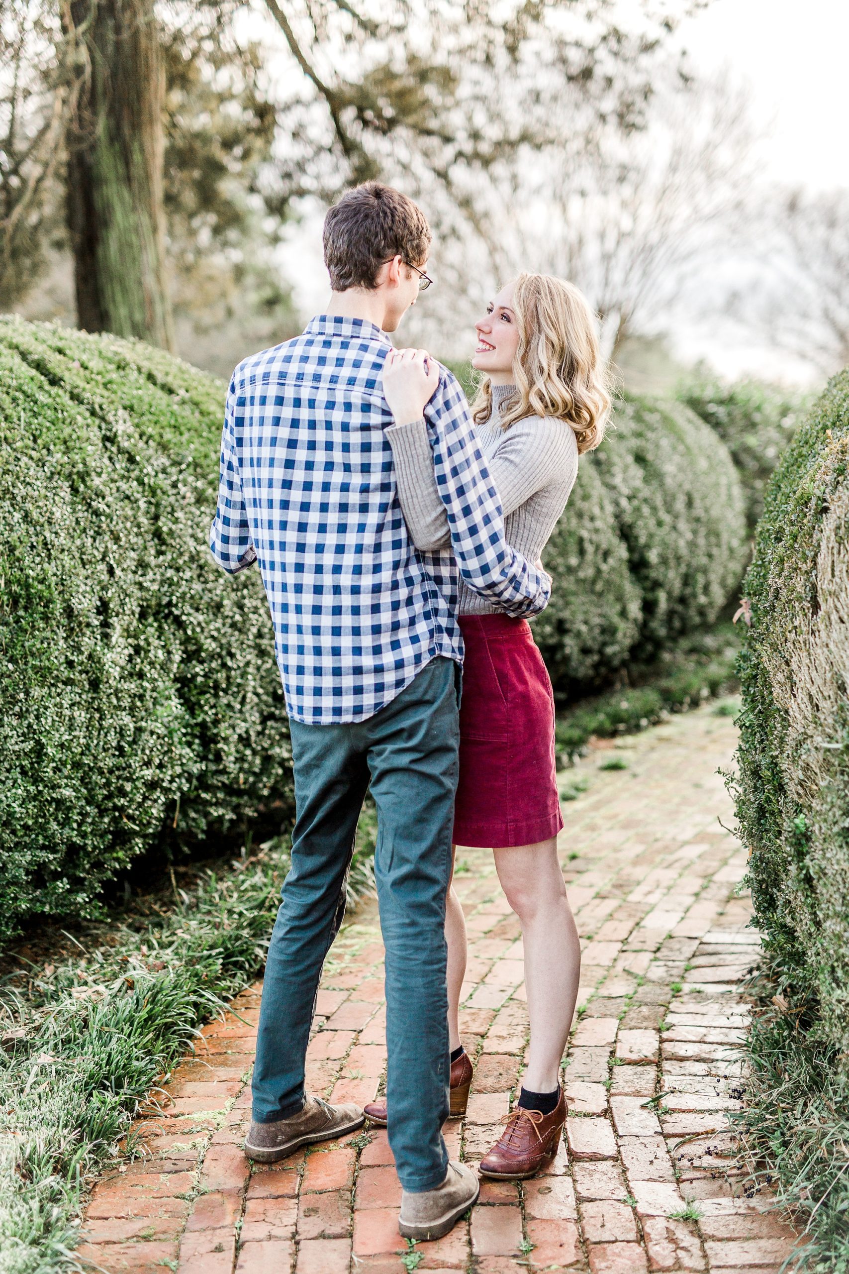 engaged couple dances on pathway during NC engagement photos