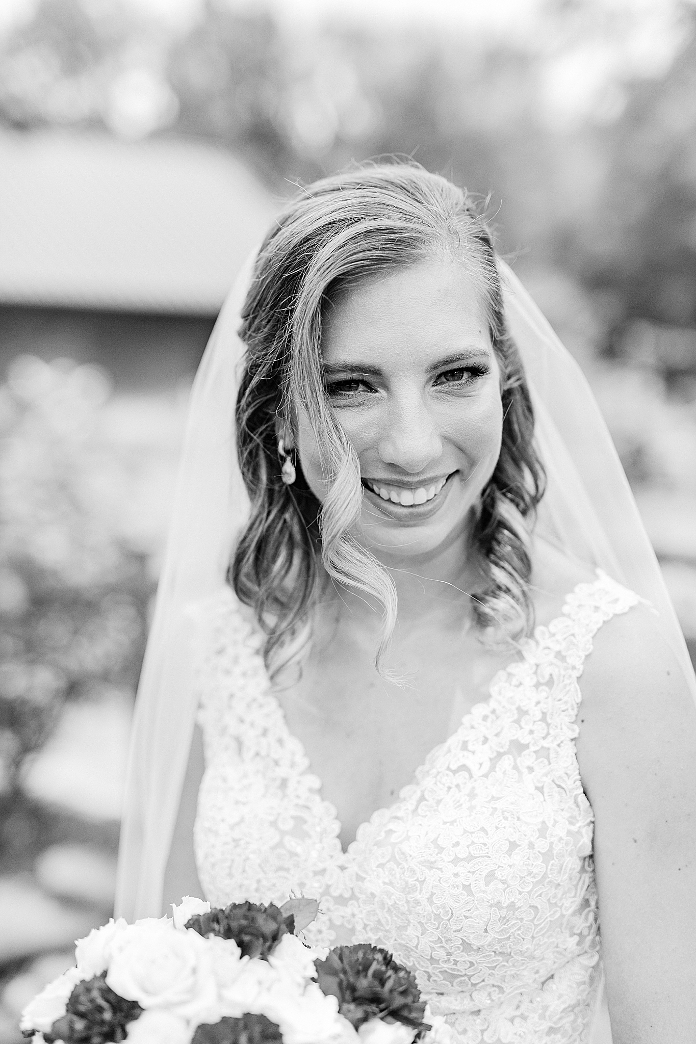 bride laughs with curl of hair hanging in her face