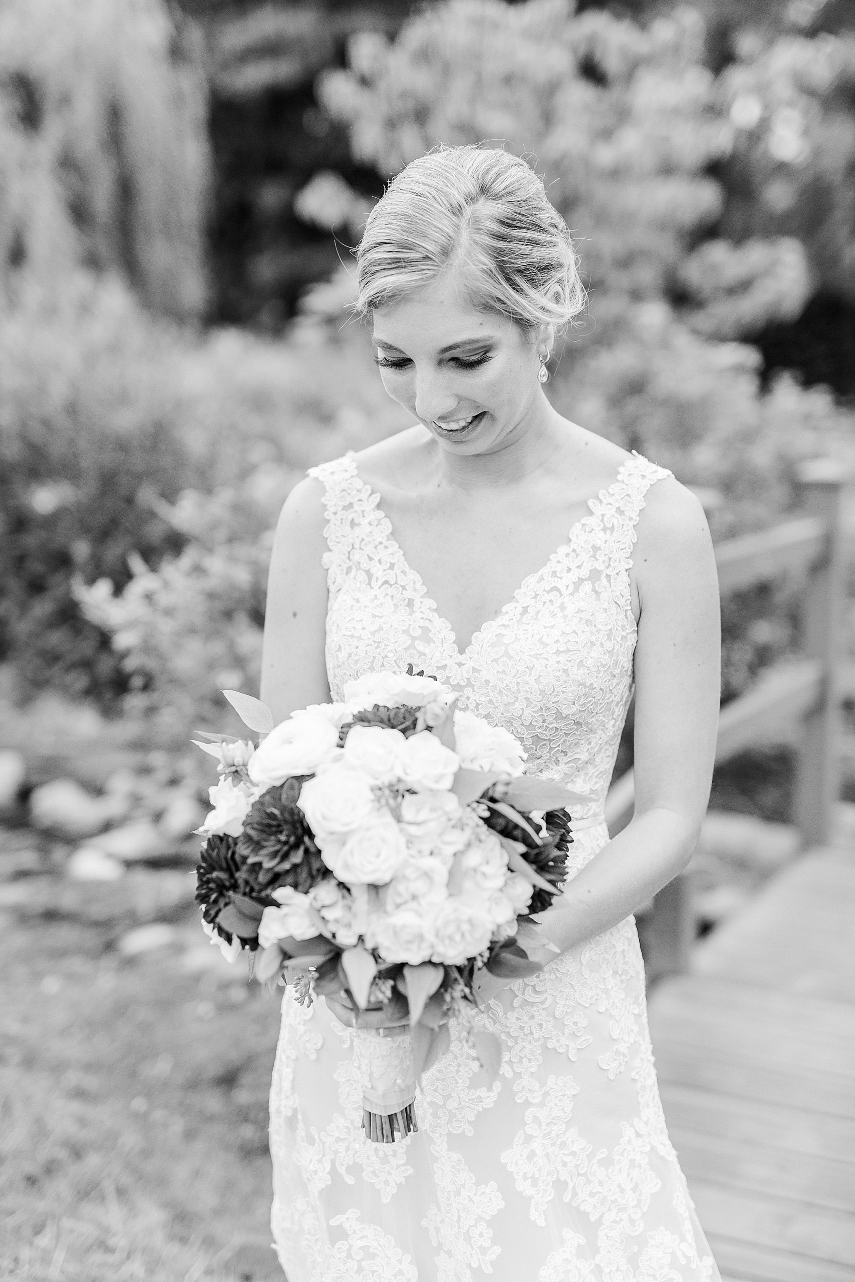 bride looks down bouquet during wedding at Alexander Homestead