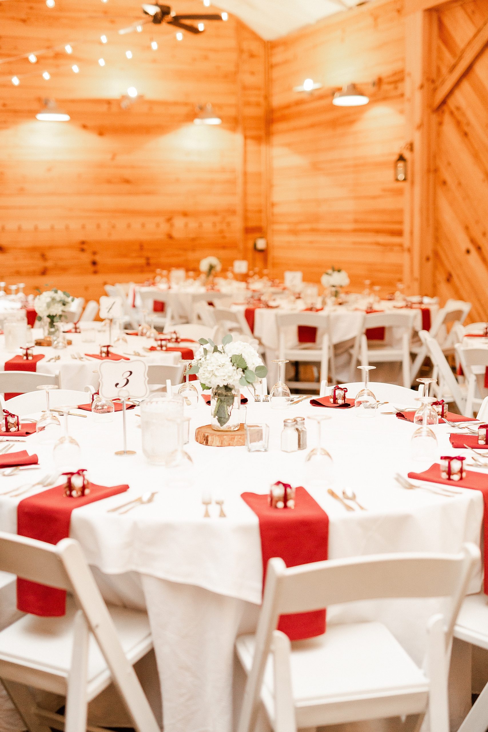 Alexander Homestead wedding reception with gold and red place settings