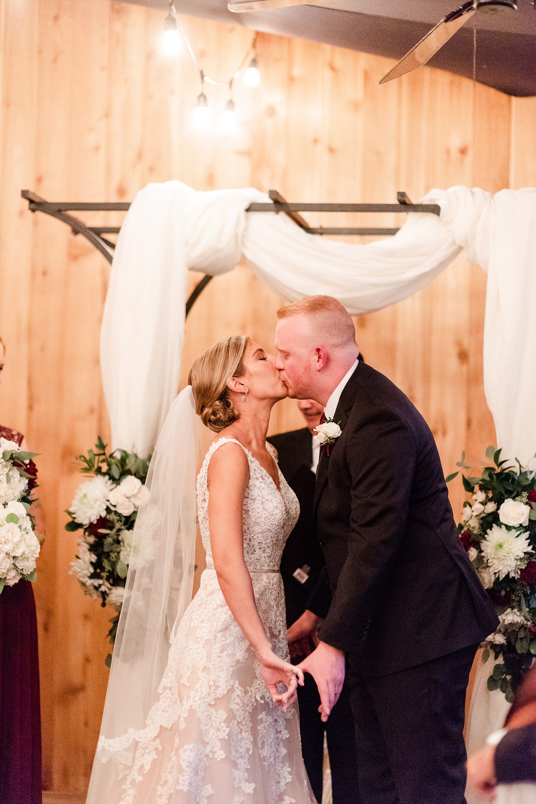 newlyweds kiss during ceremony at Alexander Homestead