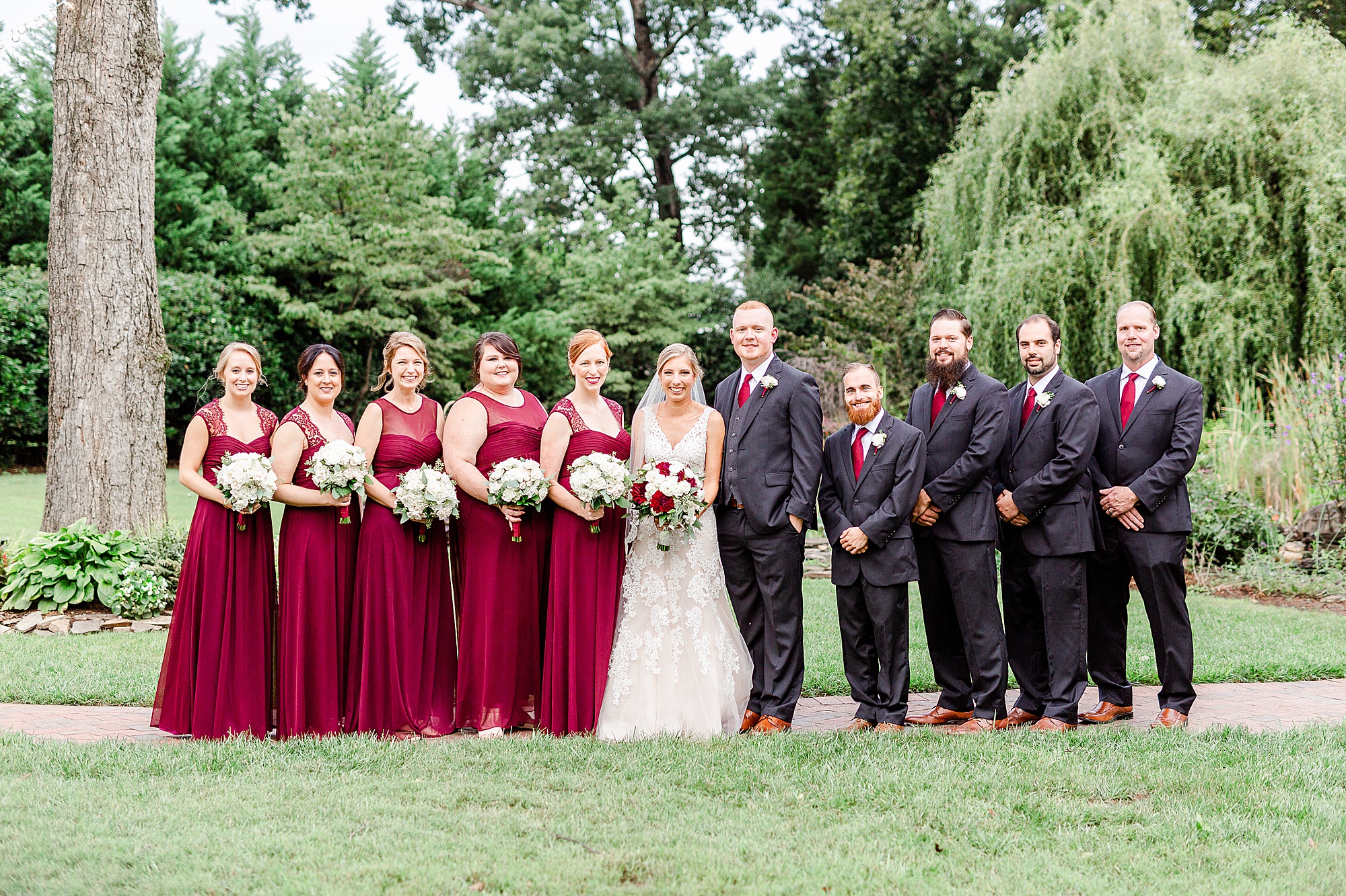 newlyweds pose with wedding party at Alexander Homestead