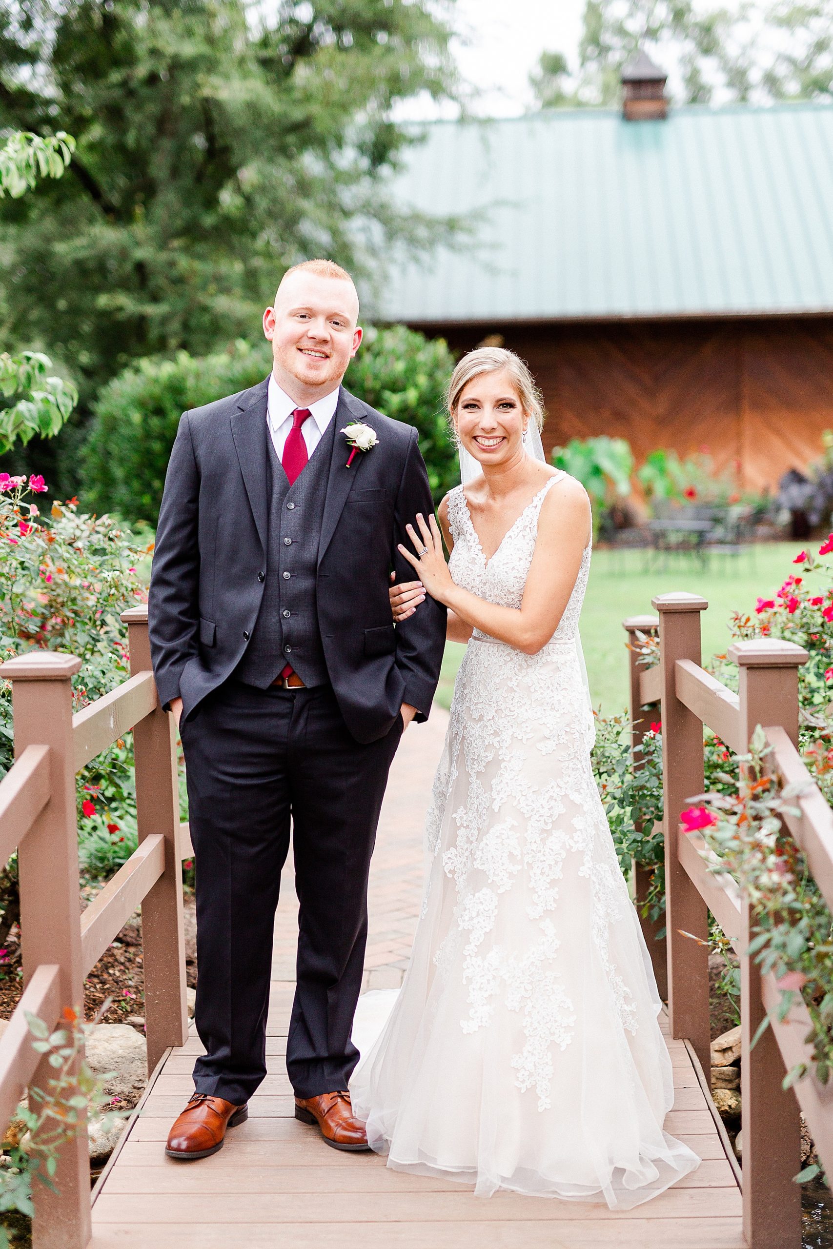 bride and gorom stand together on wooden bridge at Alexander Homestead