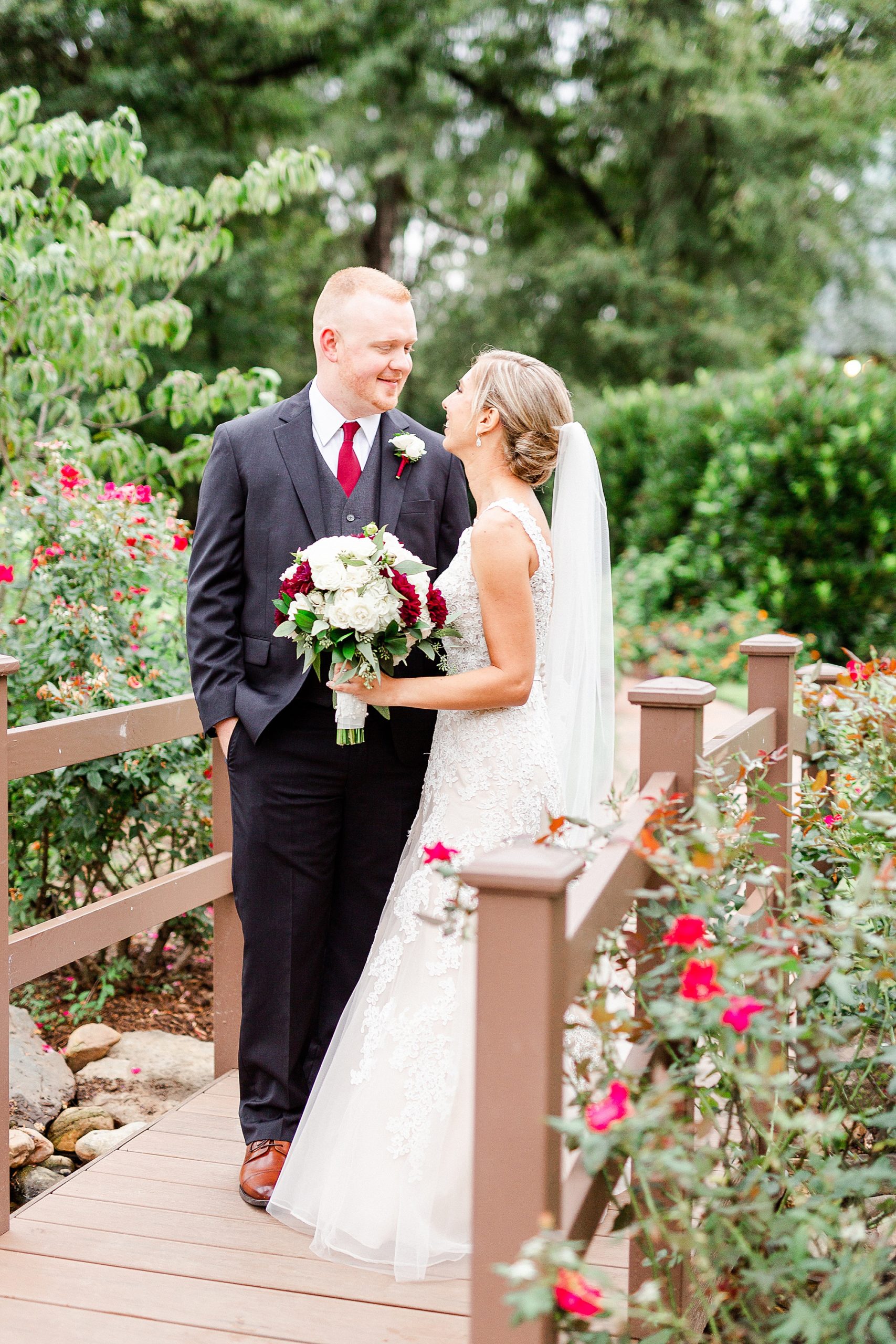 newlyweds look at each other during Summer wedding photos