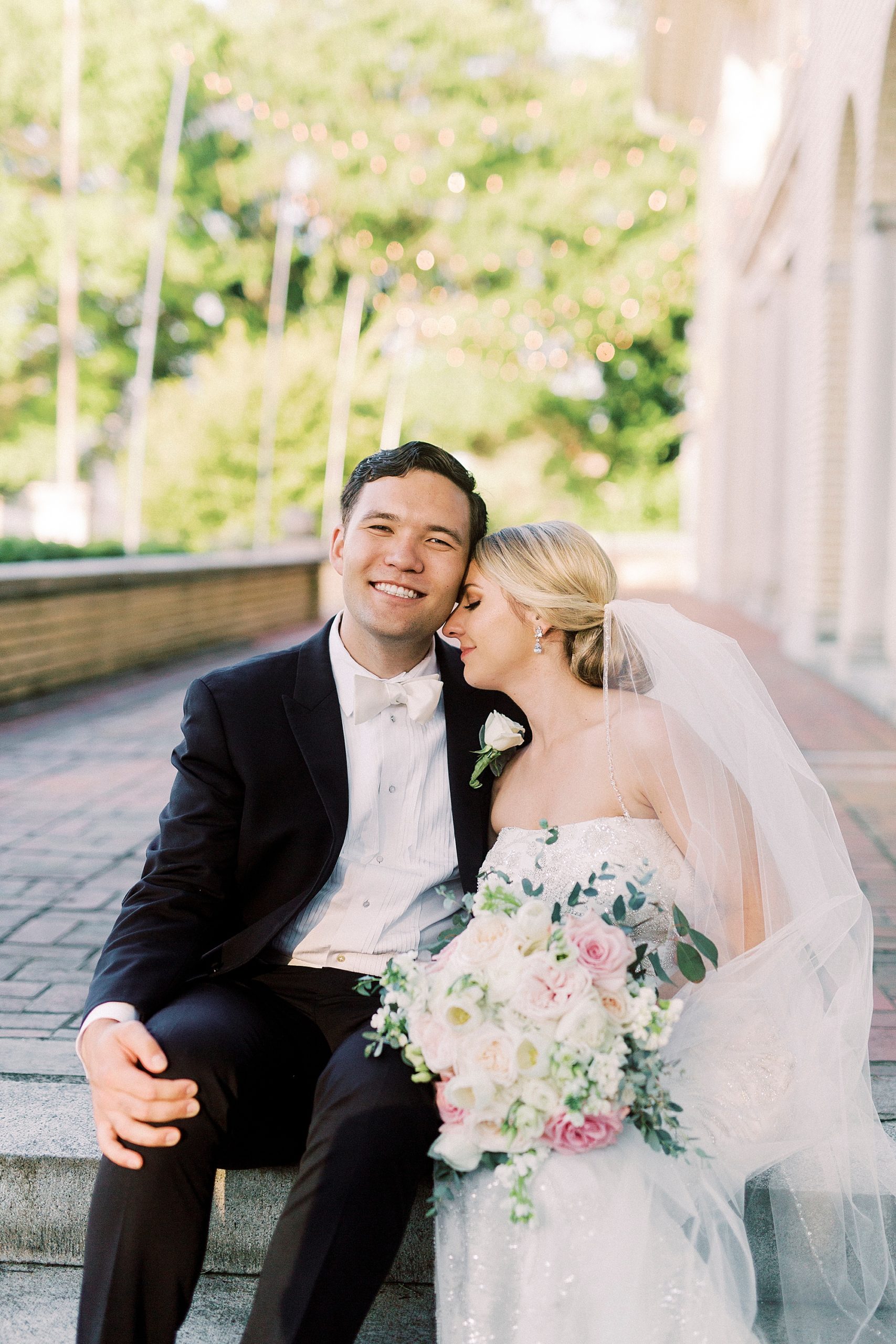 bride and groom sit on steps at Separk Mansion