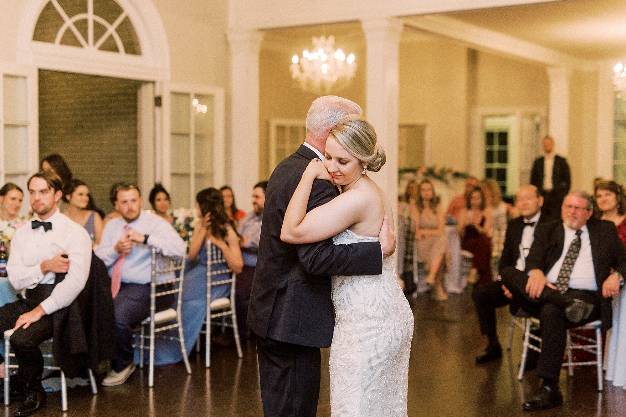 bride hugs dad during NC wedding reception