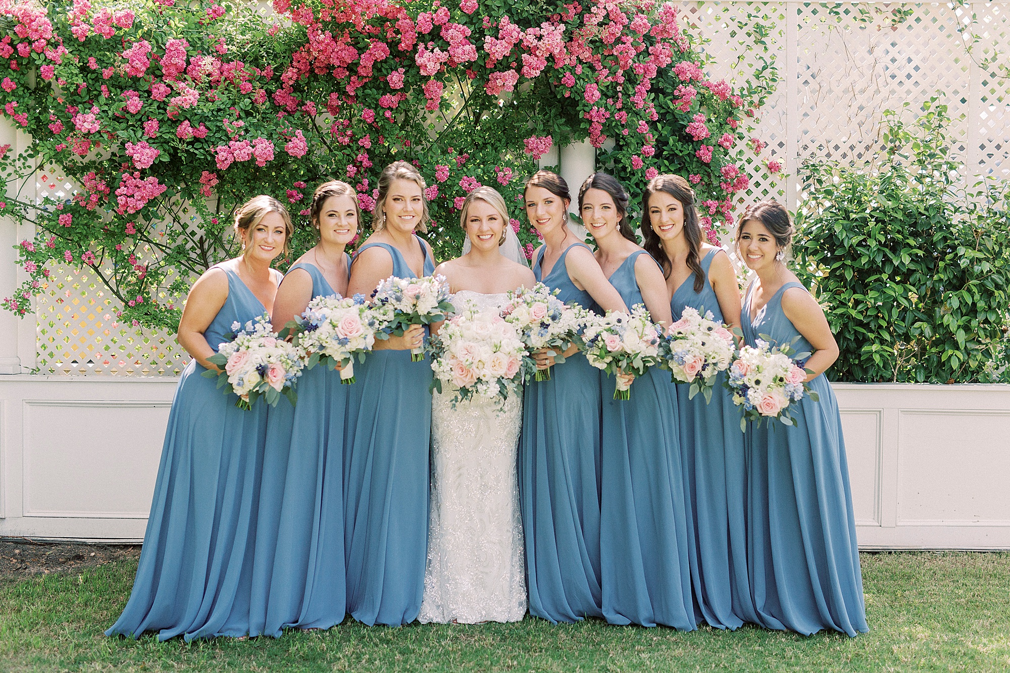 bridesmaids in light blue gowns pose together in garden at Separk Mansion