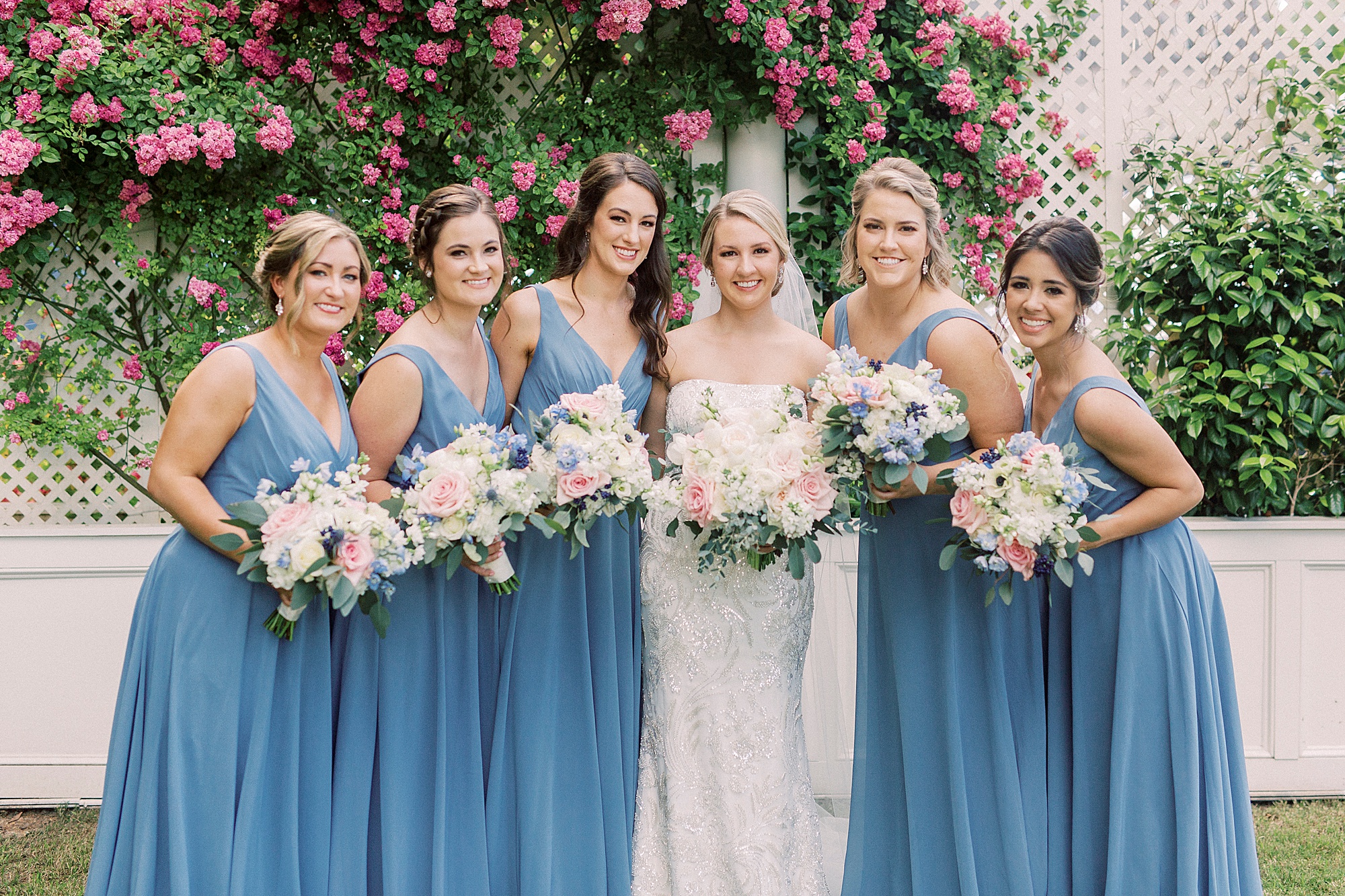 bridesmaids pose with bride outside Separk Mansion
