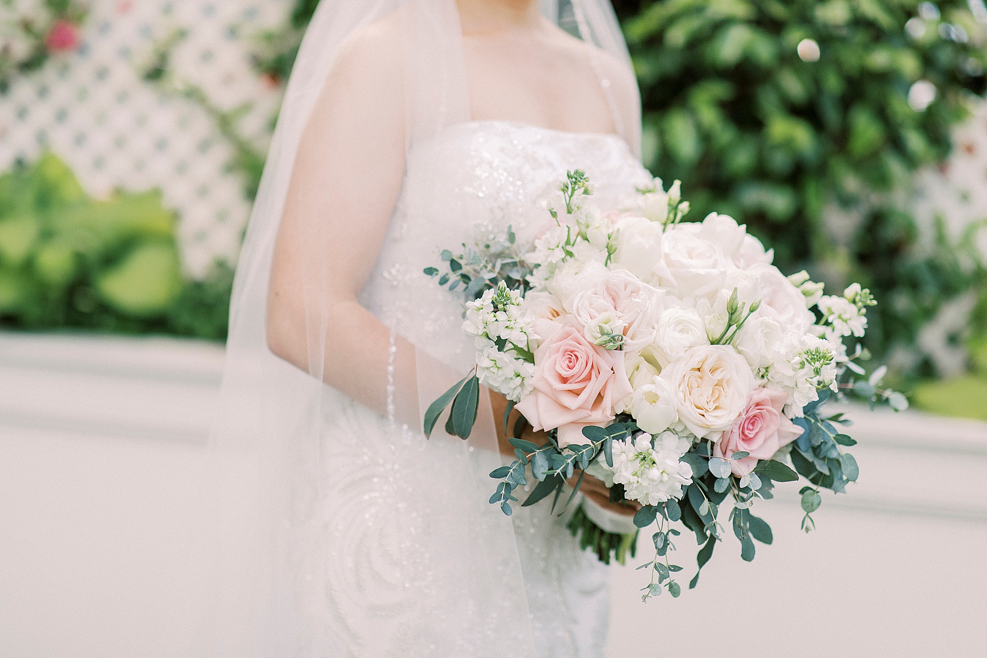 bride holds bouquet of pastel flowers for elegant Charlotte wedding