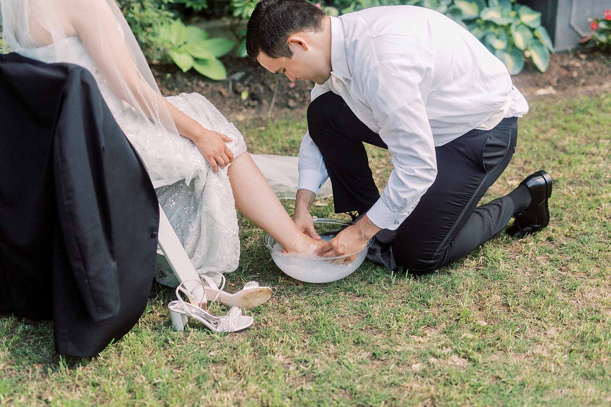 groom washes bride's feet before wedding ceremony