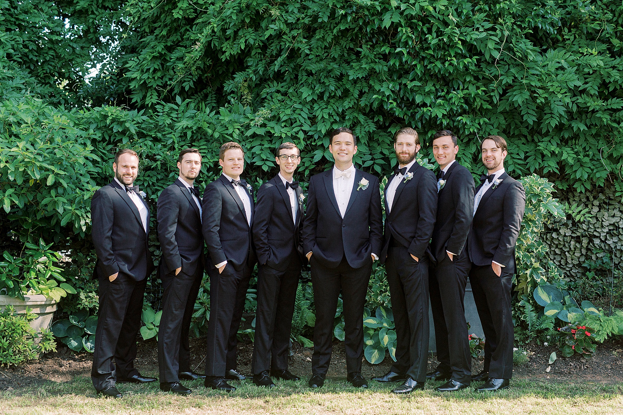 groom and groomsmen pose in classic tuxes