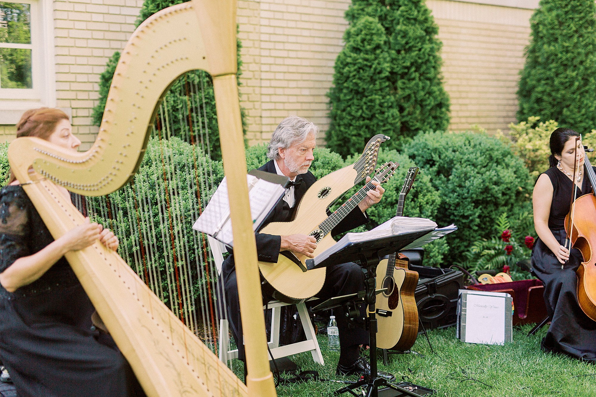 musicians play during outdoor wedding ceremony at Separk Mansion