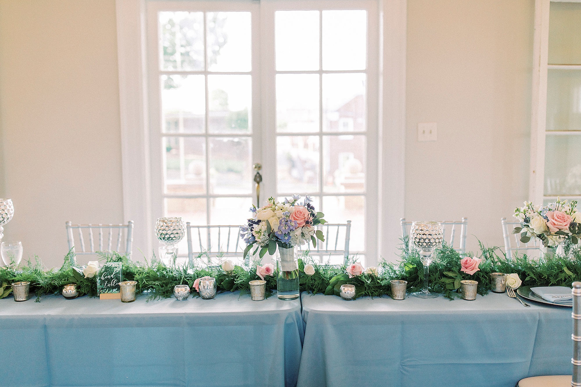sweetheart table with florals and greenery