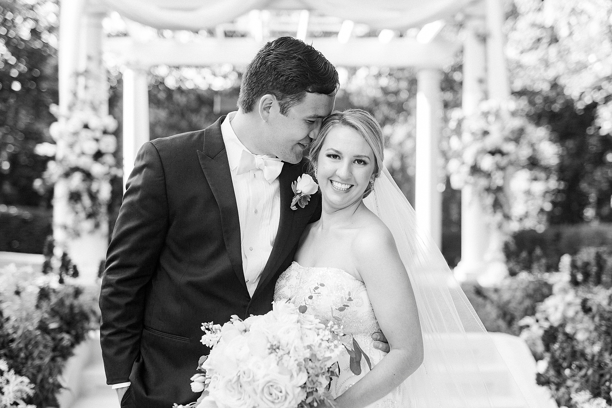 groom nuzzles bride's forehead during elegant Charlotte wedding photos
