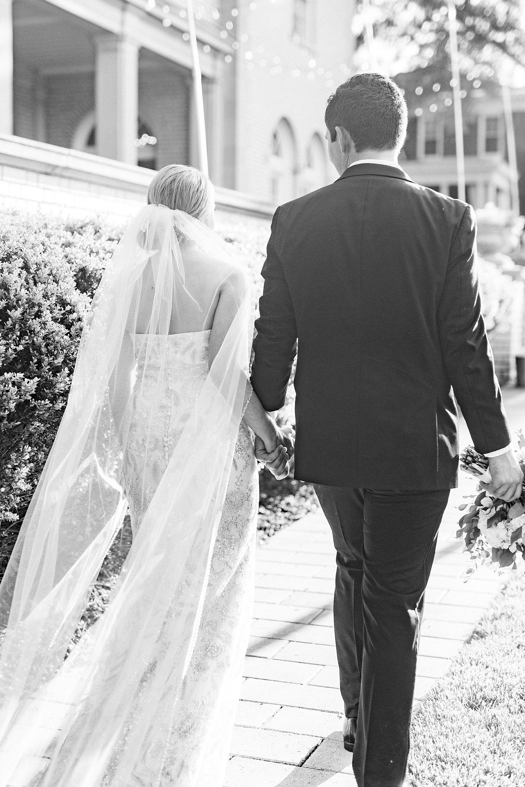 newlyweds walk together outside Separk Mansion