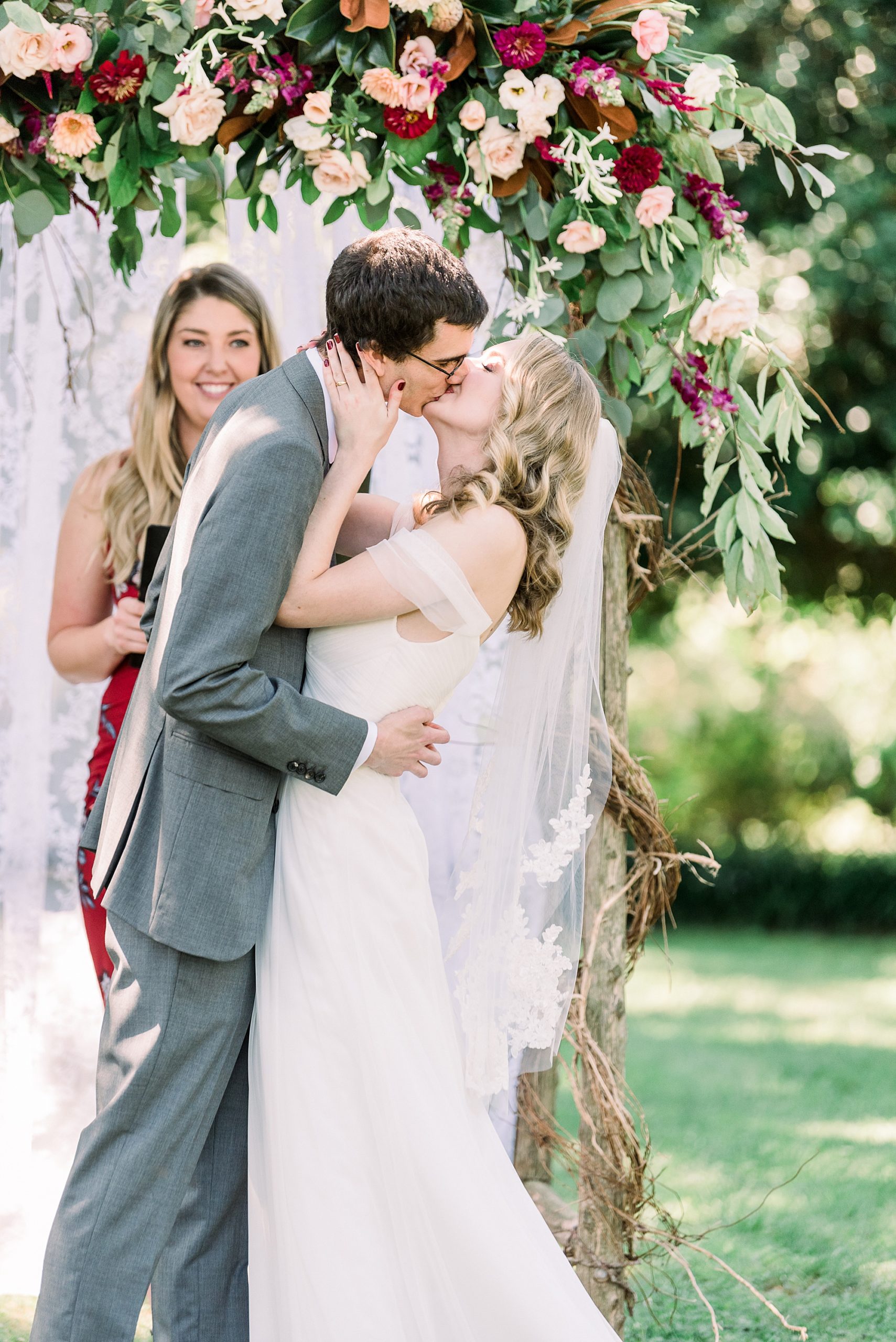 bride and groom kiss during 1812 Hitching Post wedding ceremony