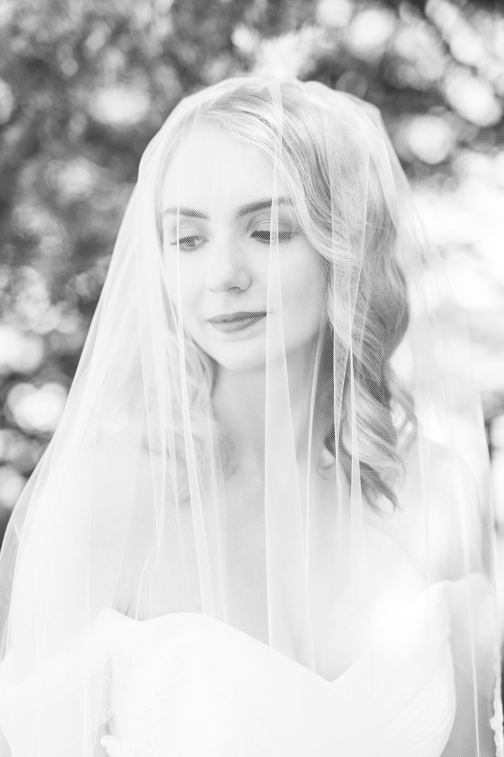 bride smiles under veil at 1812 Hitching Post