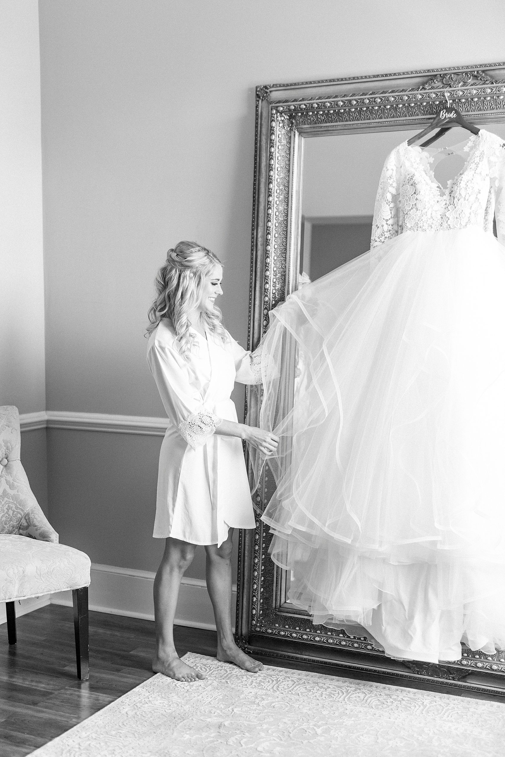 bride looks at Hayden Olivia bridal gown