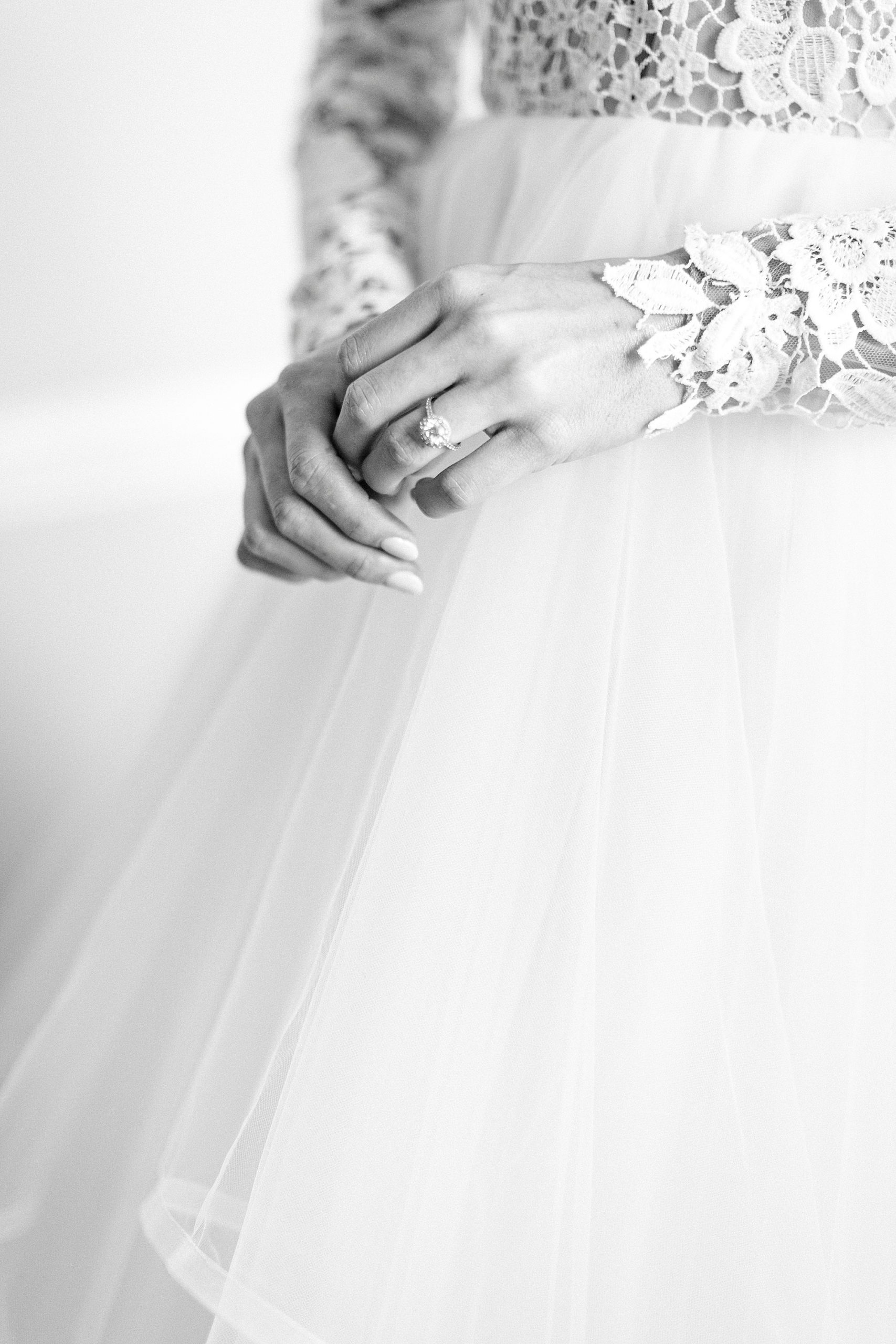 bride shows off engagement ring wearing hayden olivia bridal gown
