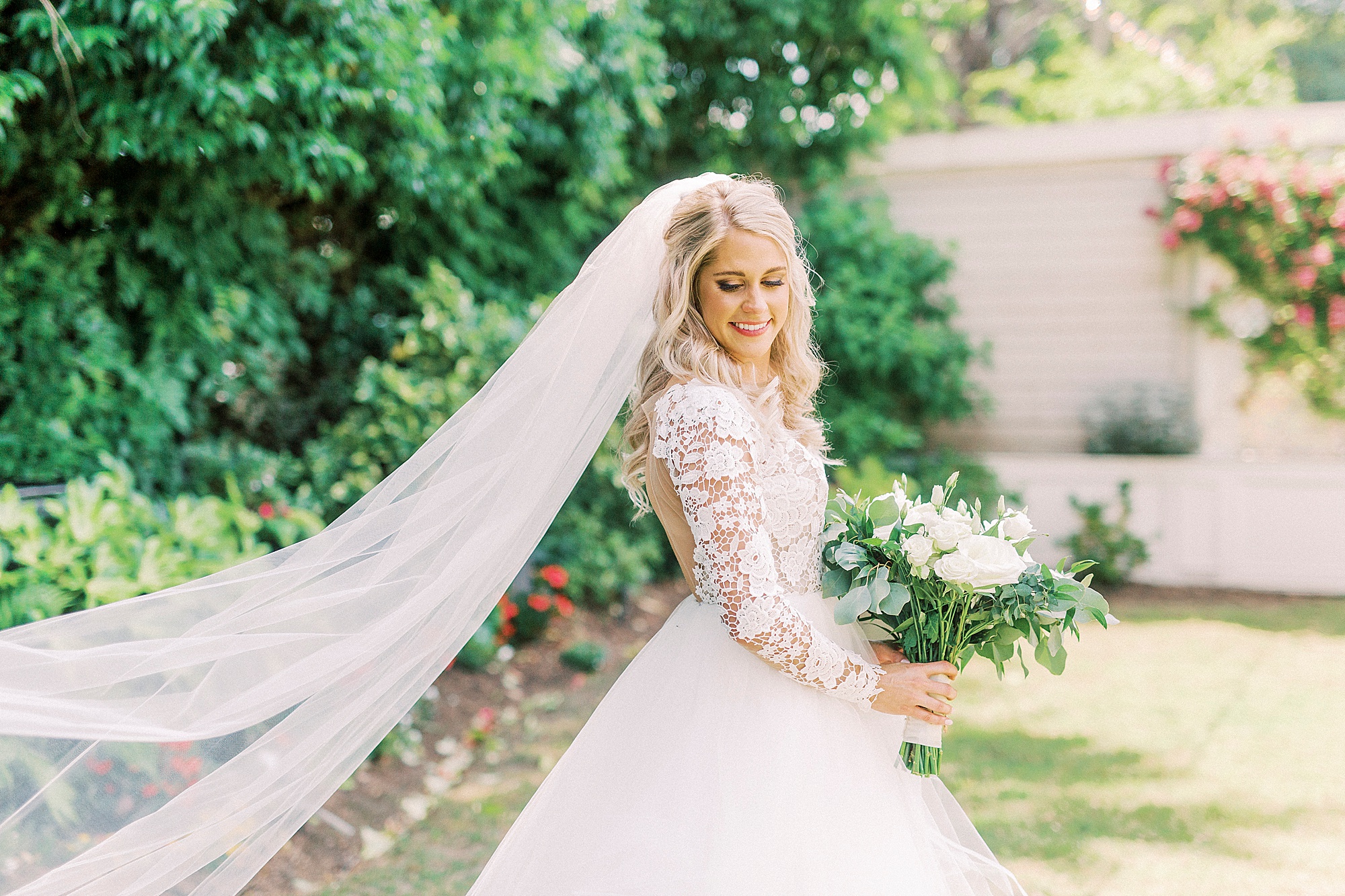 bride looks over shoulder with veil out