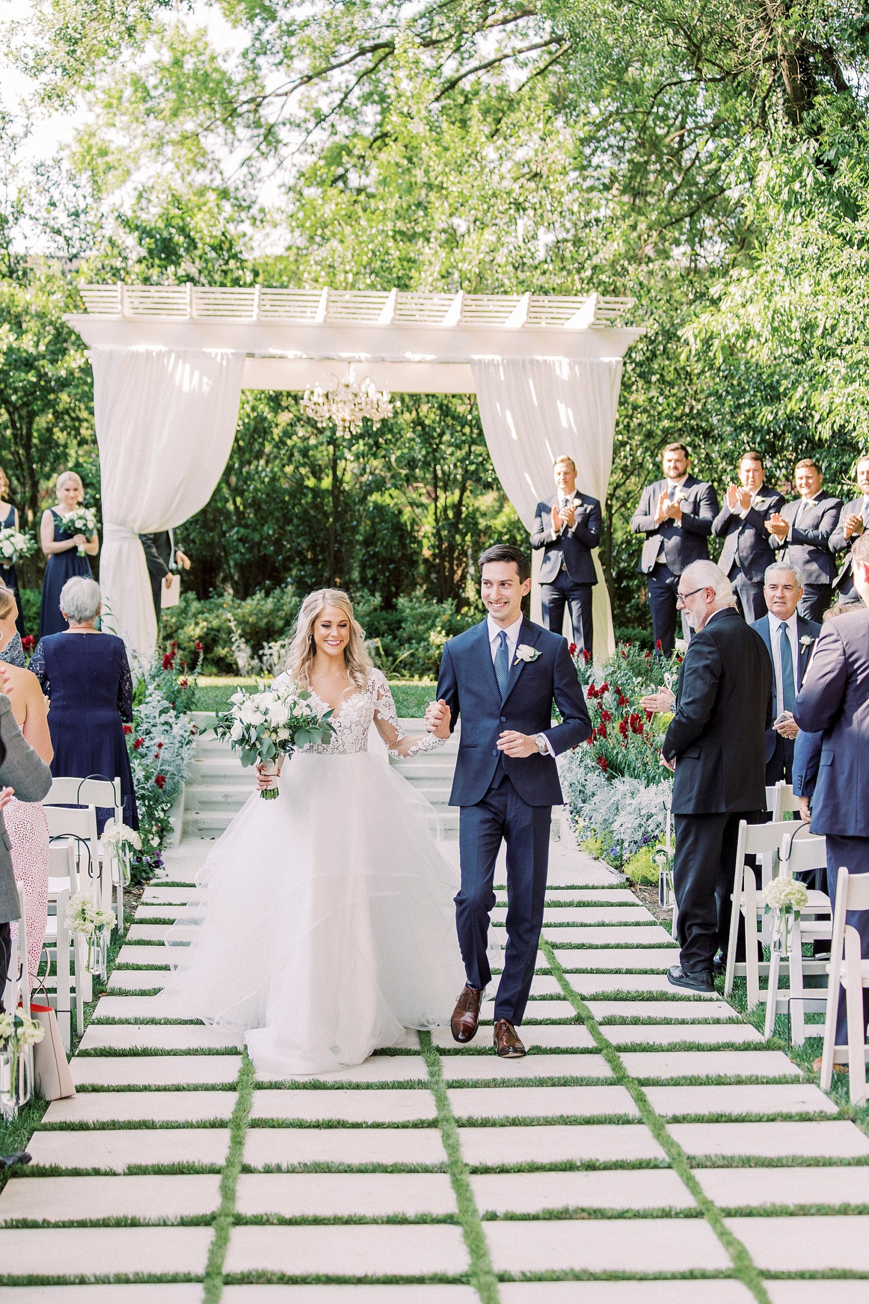 bride and groom walk up aisle during garden wedding ceremony at Separk Mansion
