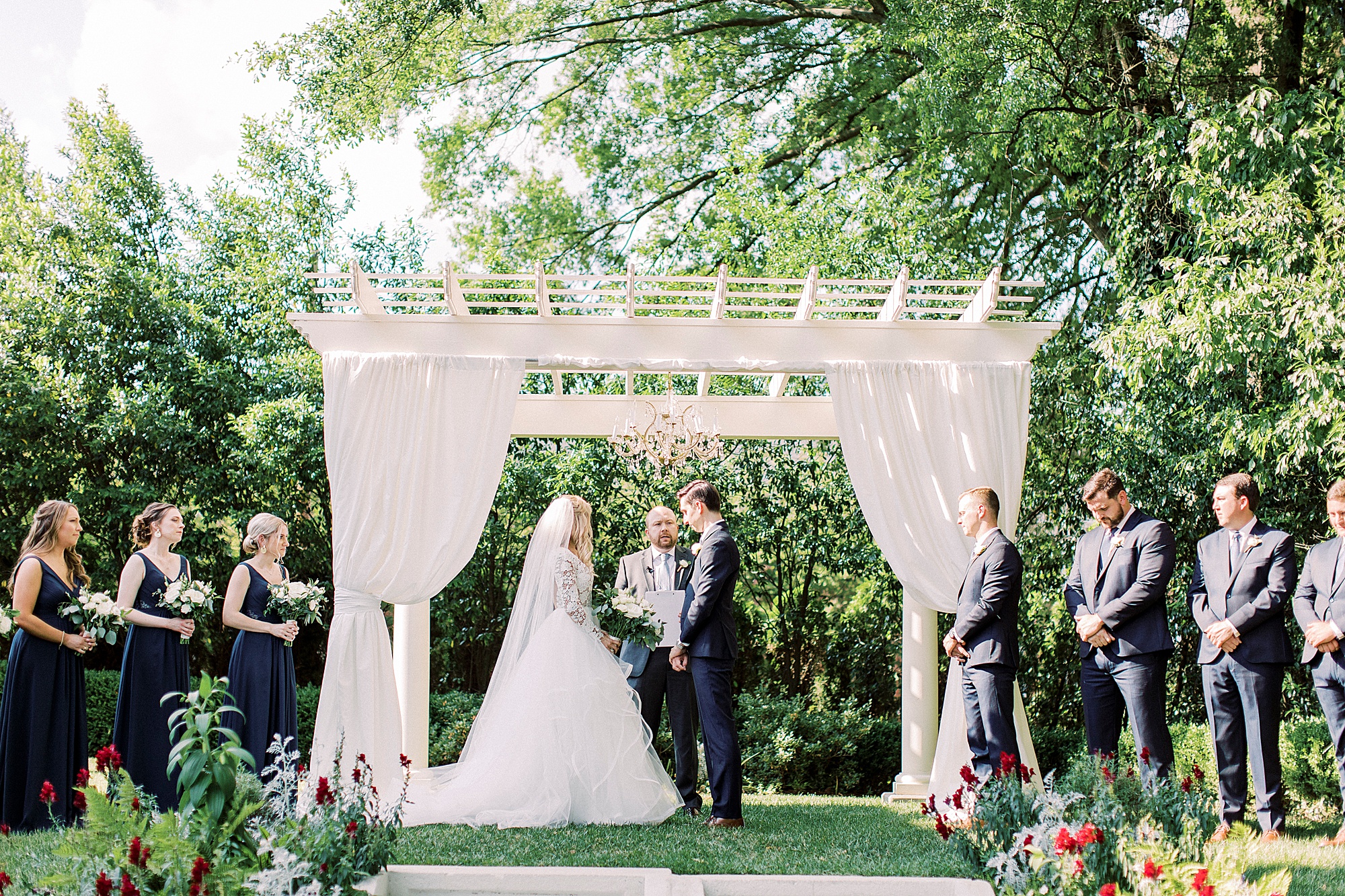 bride and groom exchange vows during garden wedding ceremony at Separk Mansion