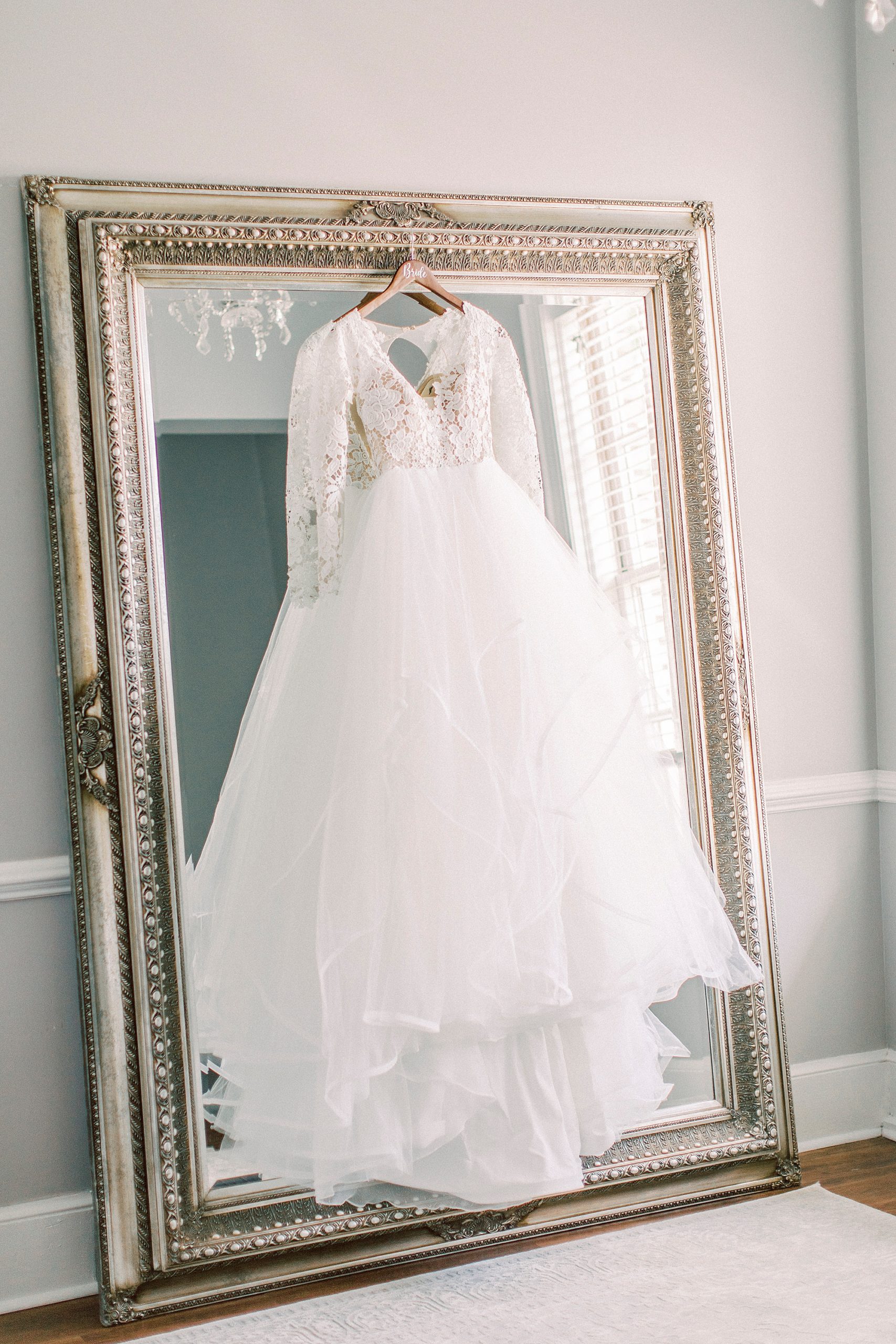 Hayden Olivia bridal gown hangs on mirror at Separk Mansion