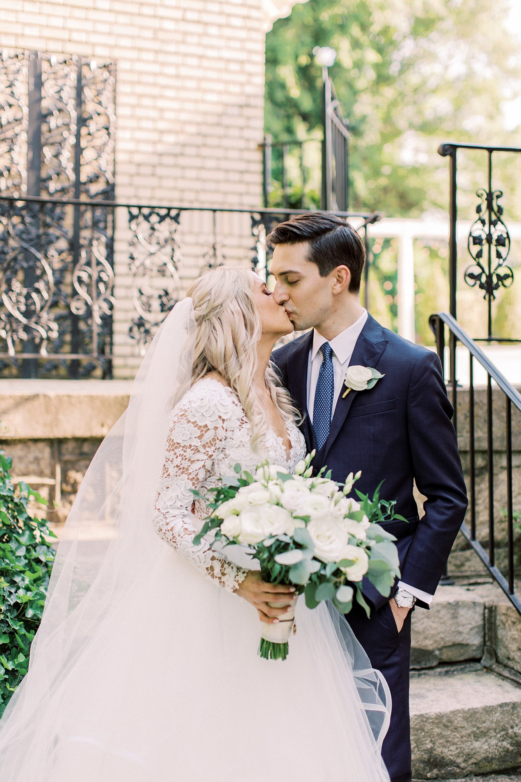 newlyweds kiss by steps at Separk Mansion