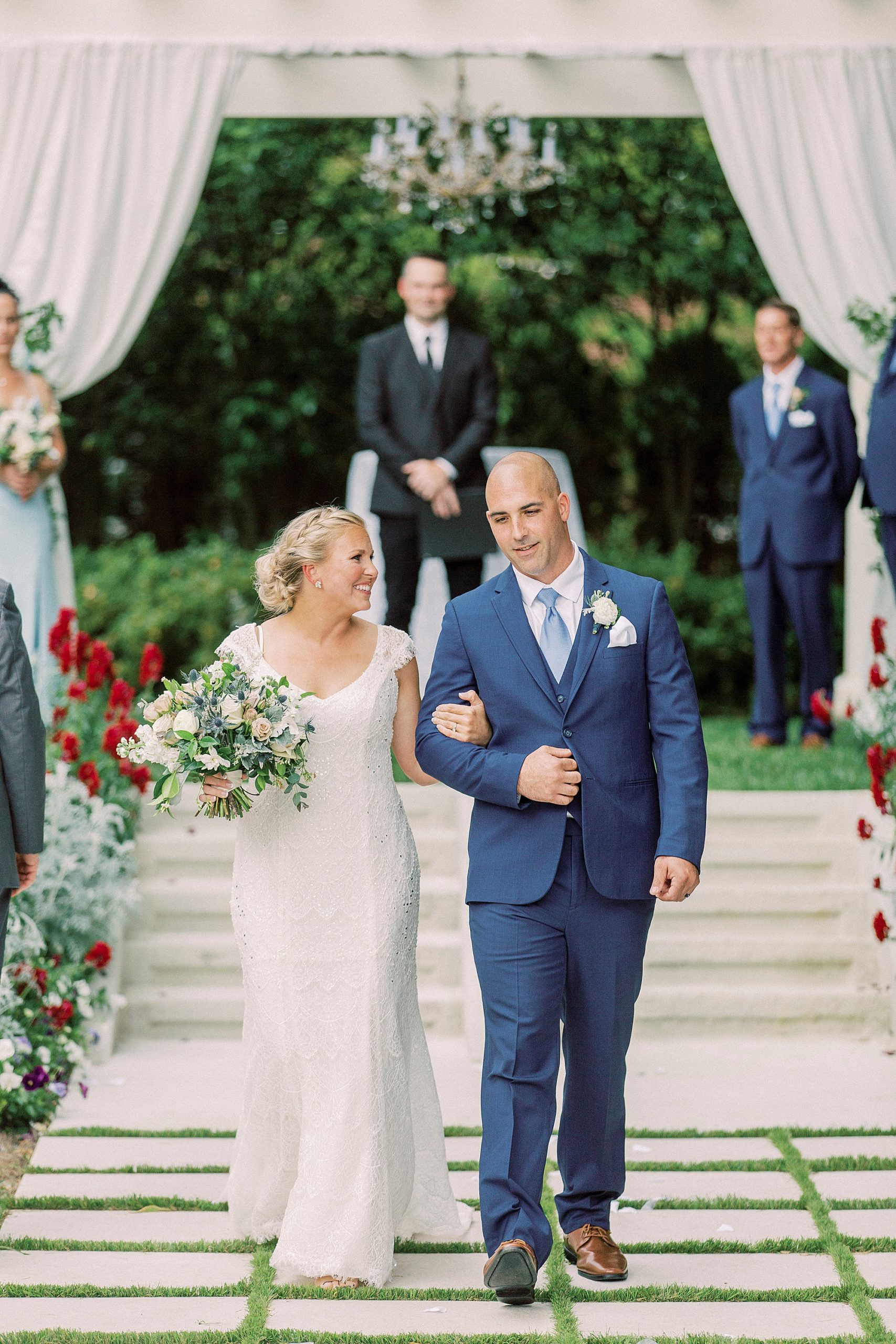 newlyweds walk up aisle after wedding ceremony at Separk Mansion
