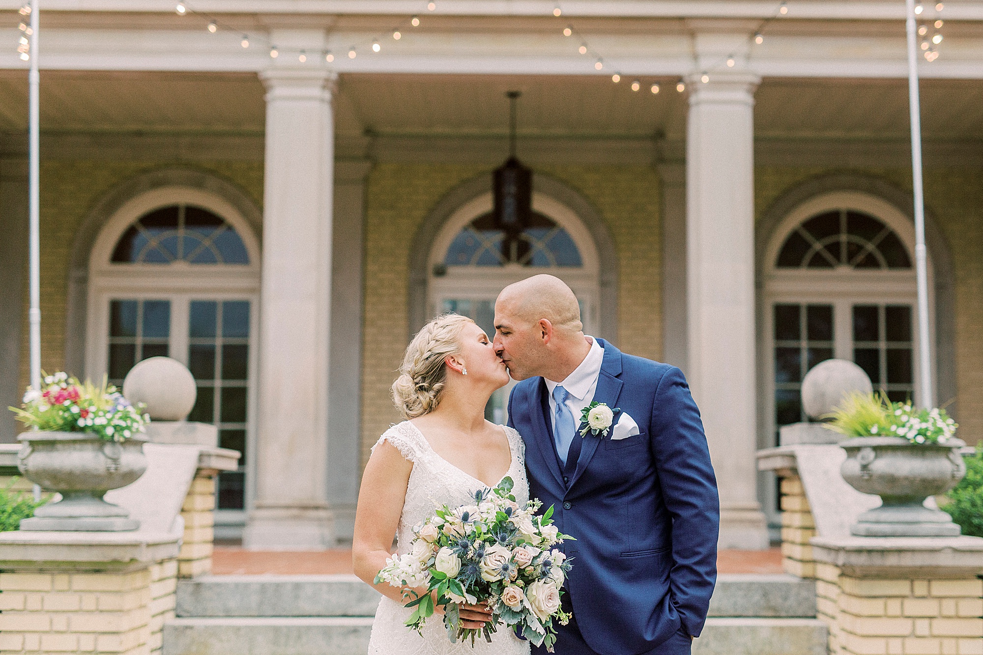 newlyweds kiss outside Separk Mansion in Charlotte, NC