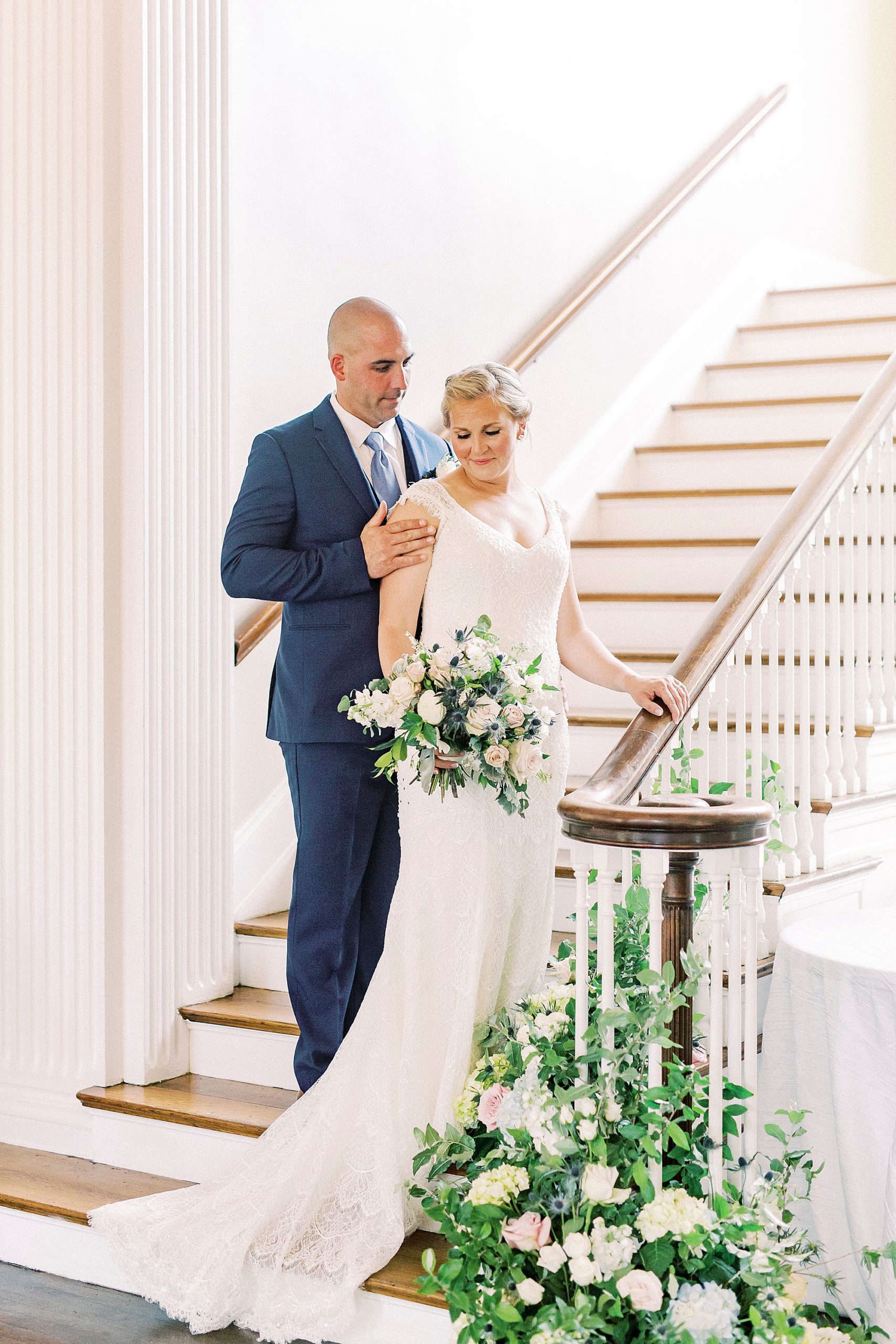 newlyweds stand on staircase in Separk Mansion