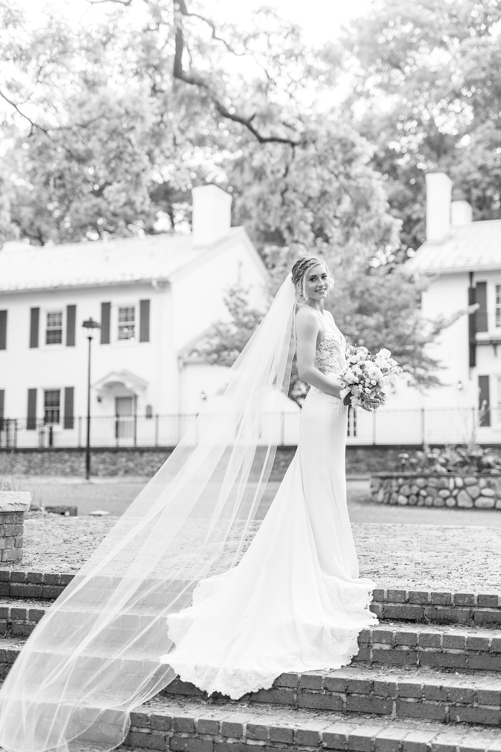 bride poses on steps at Tanglewood Park