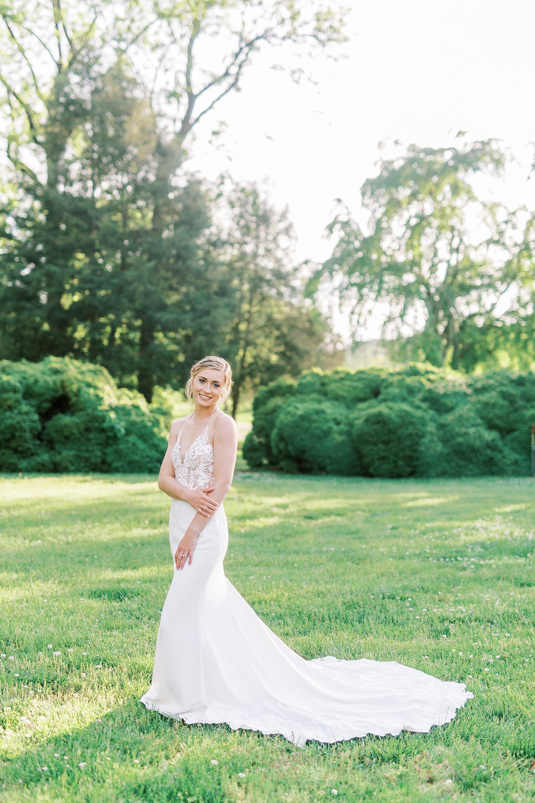 bride stands in field at Tanglewood Park