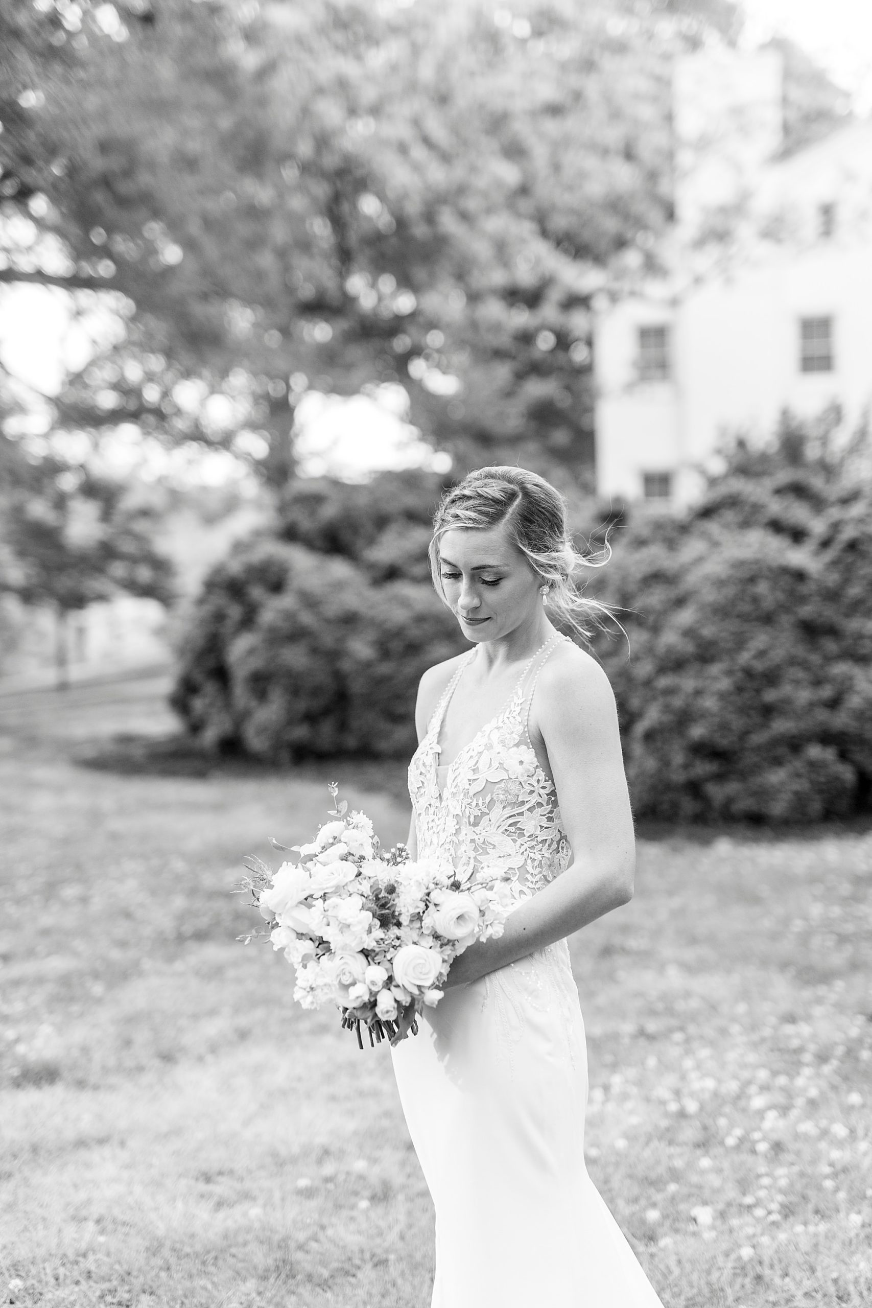 bride looks down at bouquet during Tanglewood bridal portraits