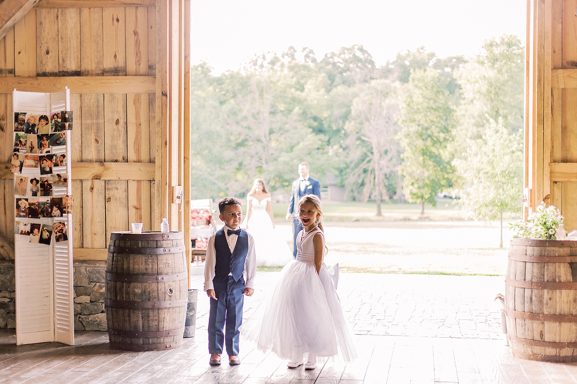 flower girls and ring bearer enter reception at The Farmstead