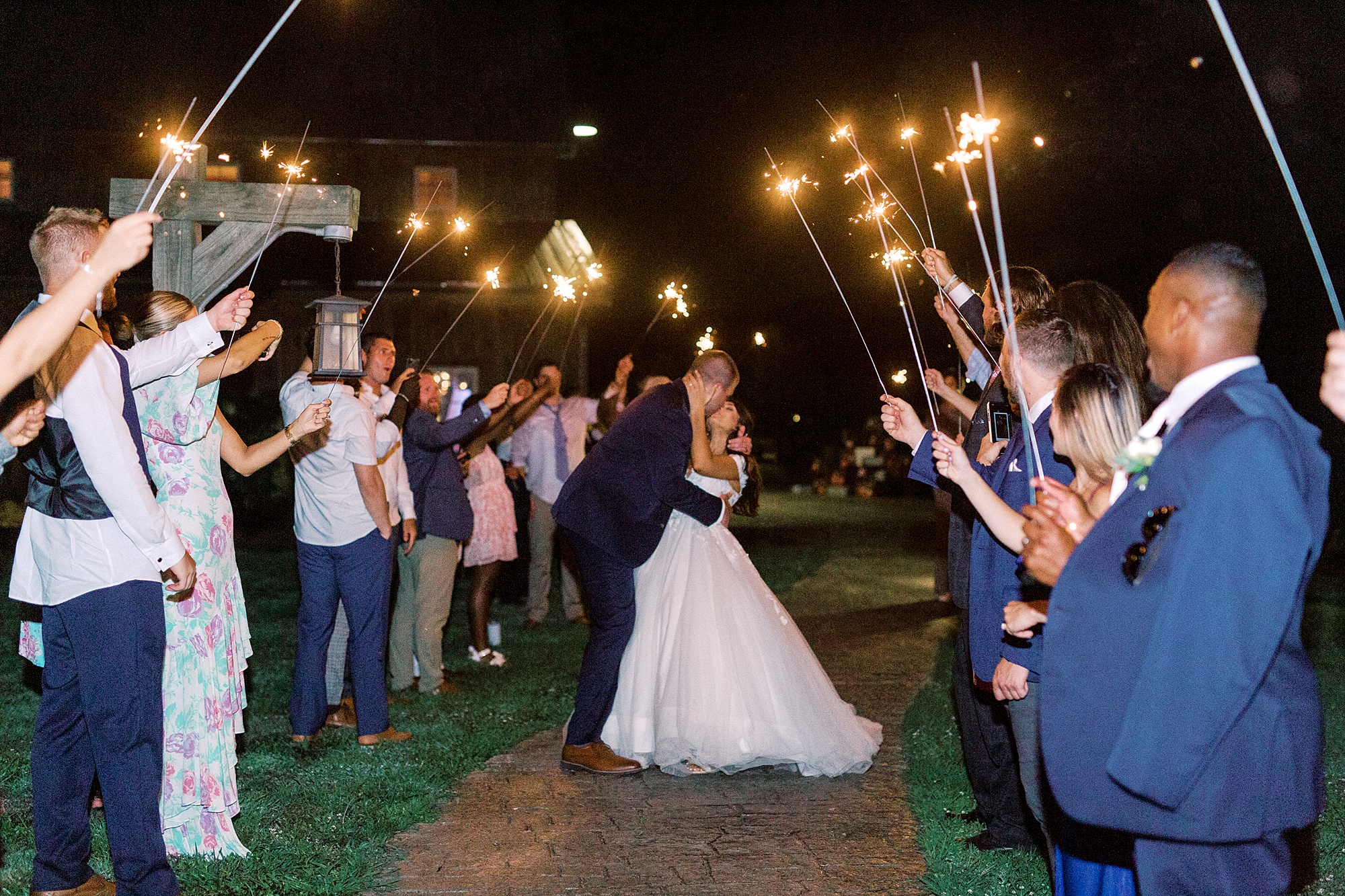 bride and groom kiss during sparkler exit