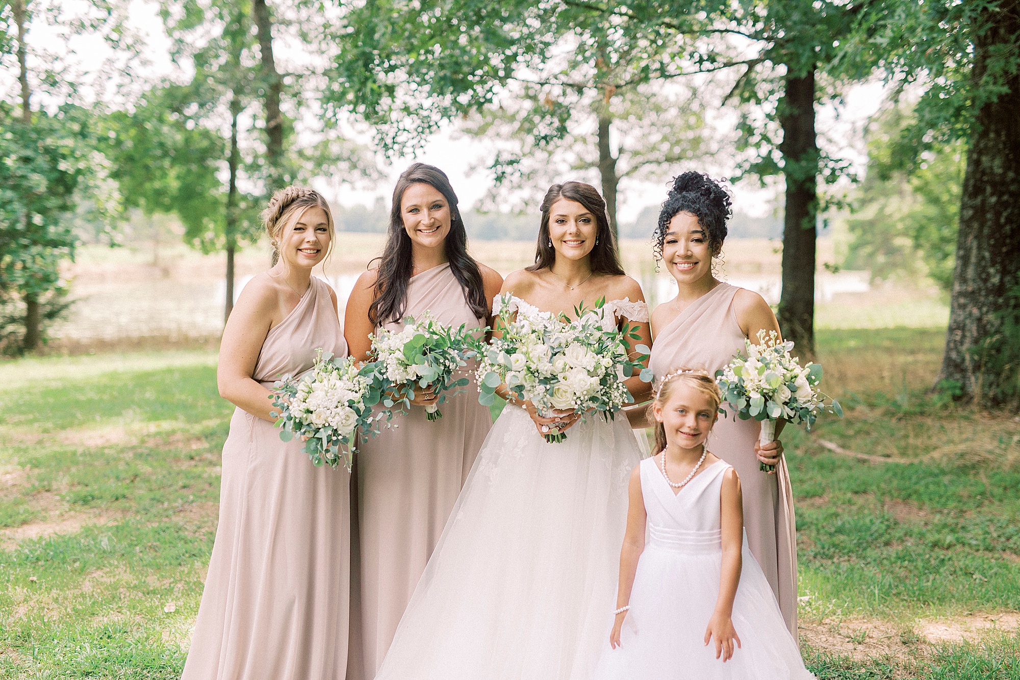 bride and b bridesmaids pose in pink gowns