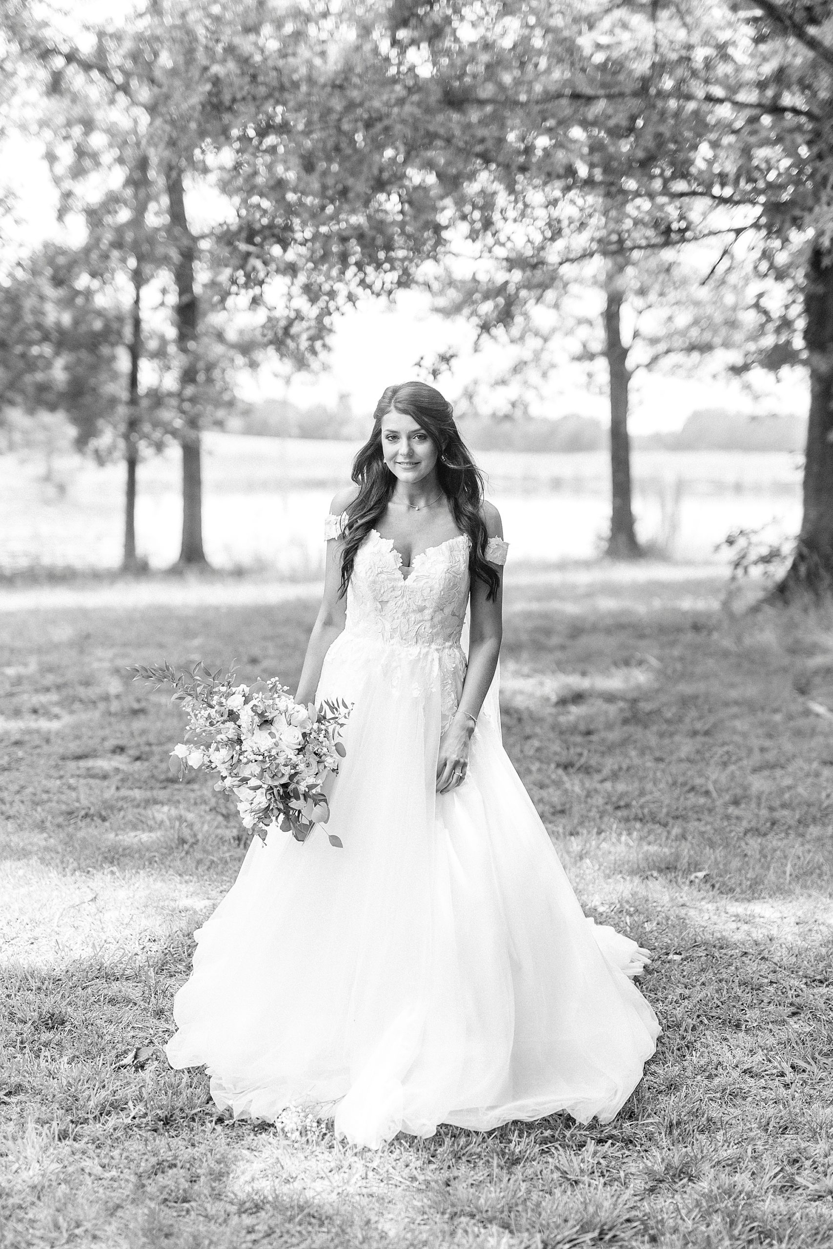 bride walks in wedding gown outside The Farmstead