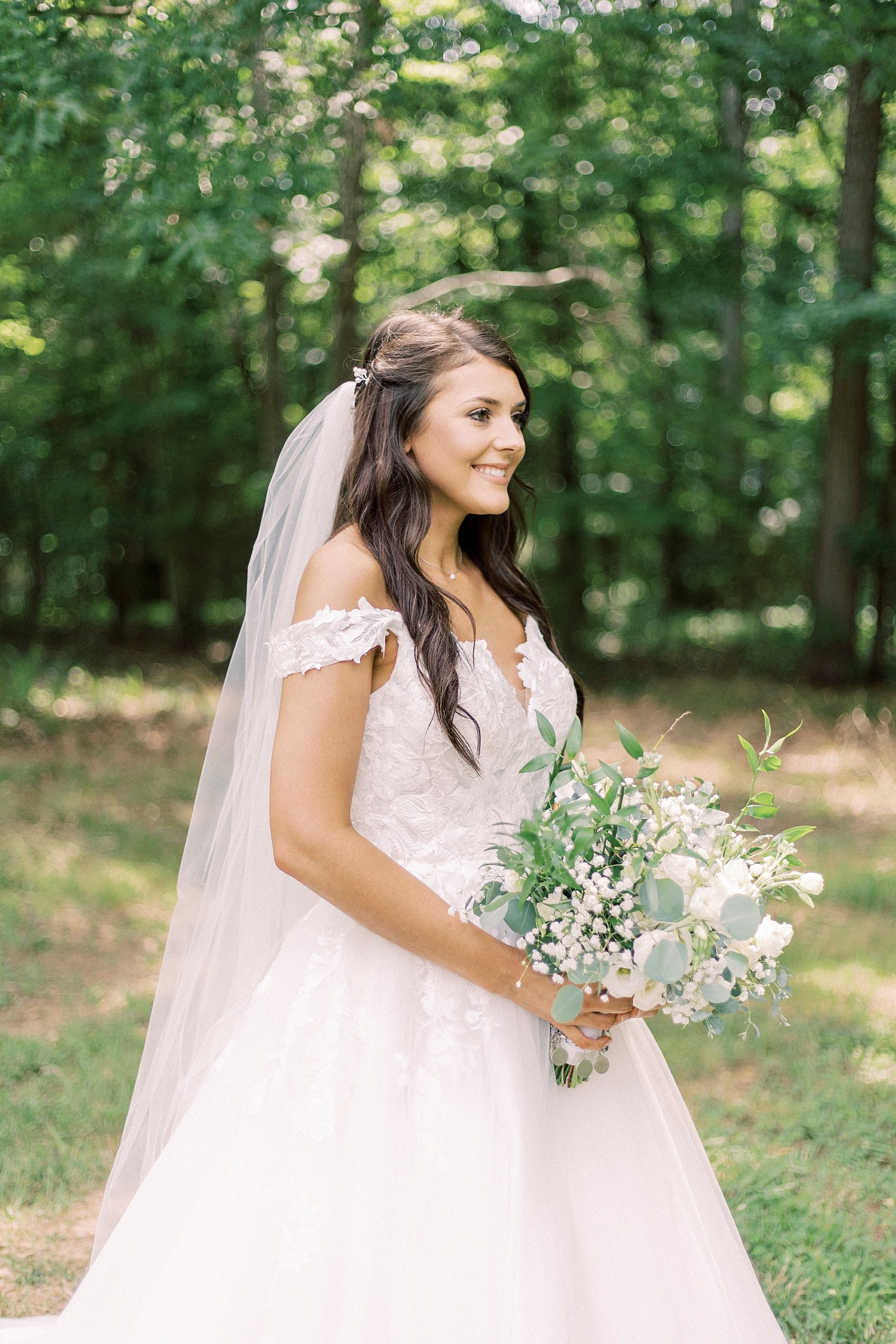 bride holds bouquet of green and ivory at The Farmstead