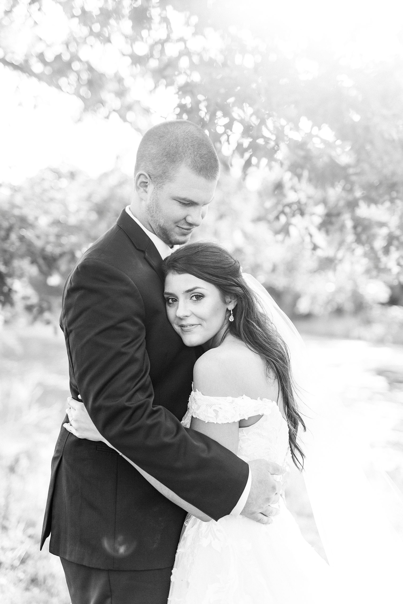 groom holds bride during The Farmstead wedding portraits
