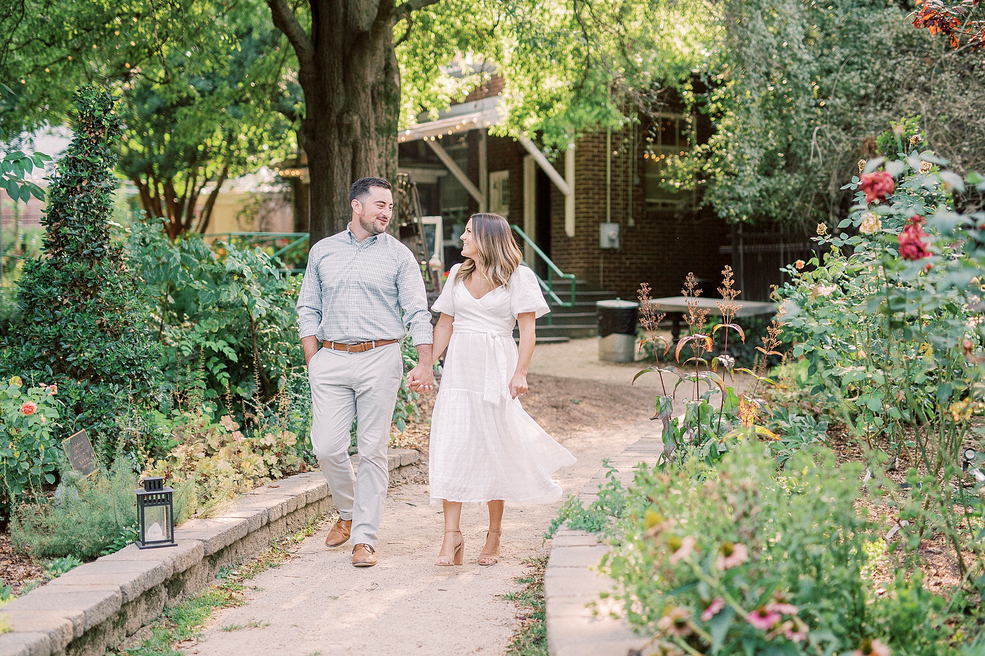 engaged couple walks through McGill Rose Garden