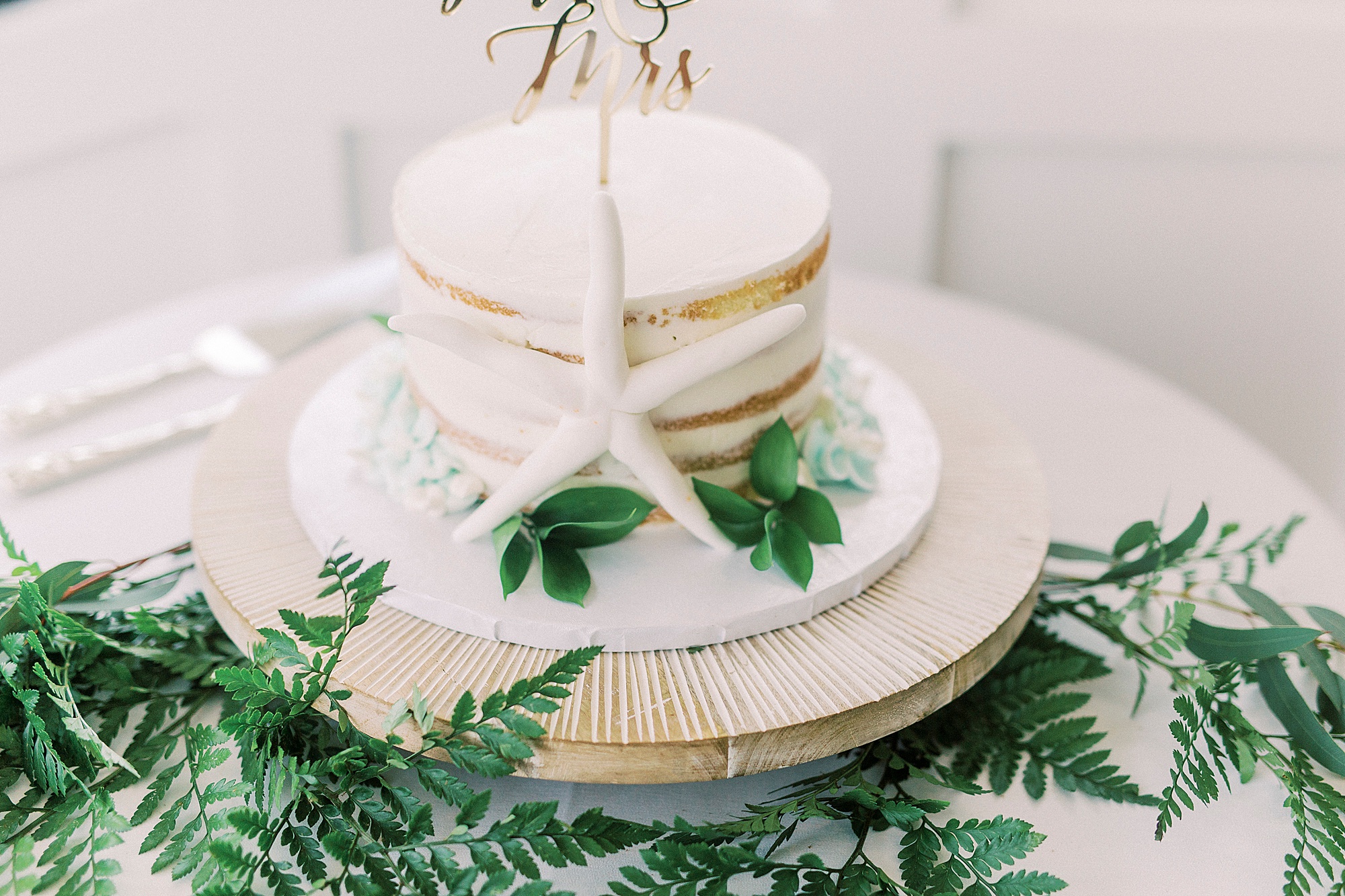 short naked wedding cake with starfish detail