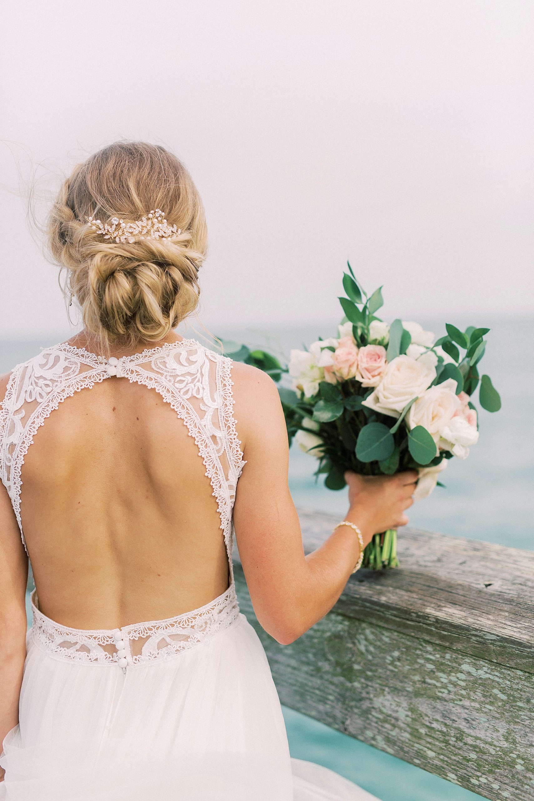 bride shows off open back wedding gown