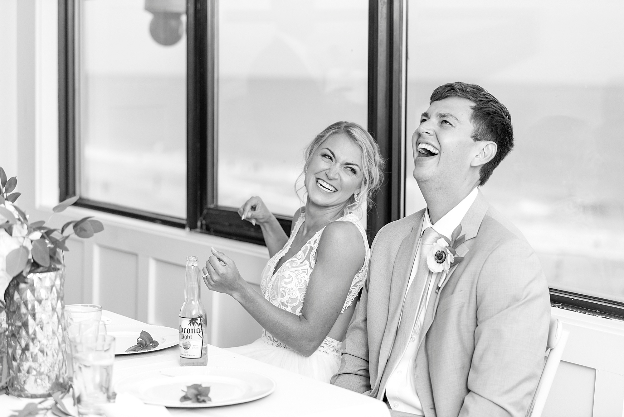 newlyweds laugh during toasts at Oceanic Restaurant