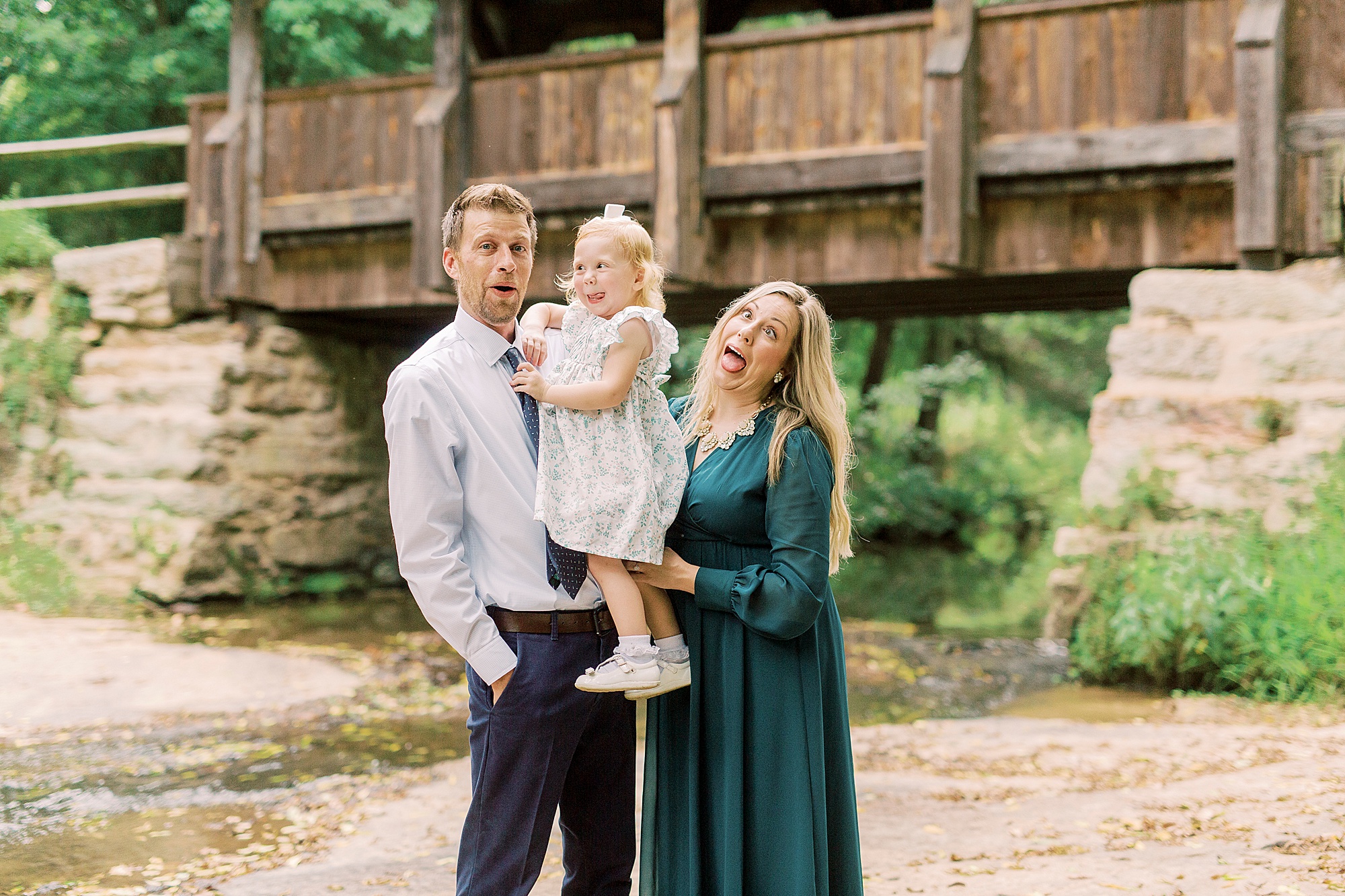 family makes silly faces with toddler during portraits at Vesuvius Vineyards