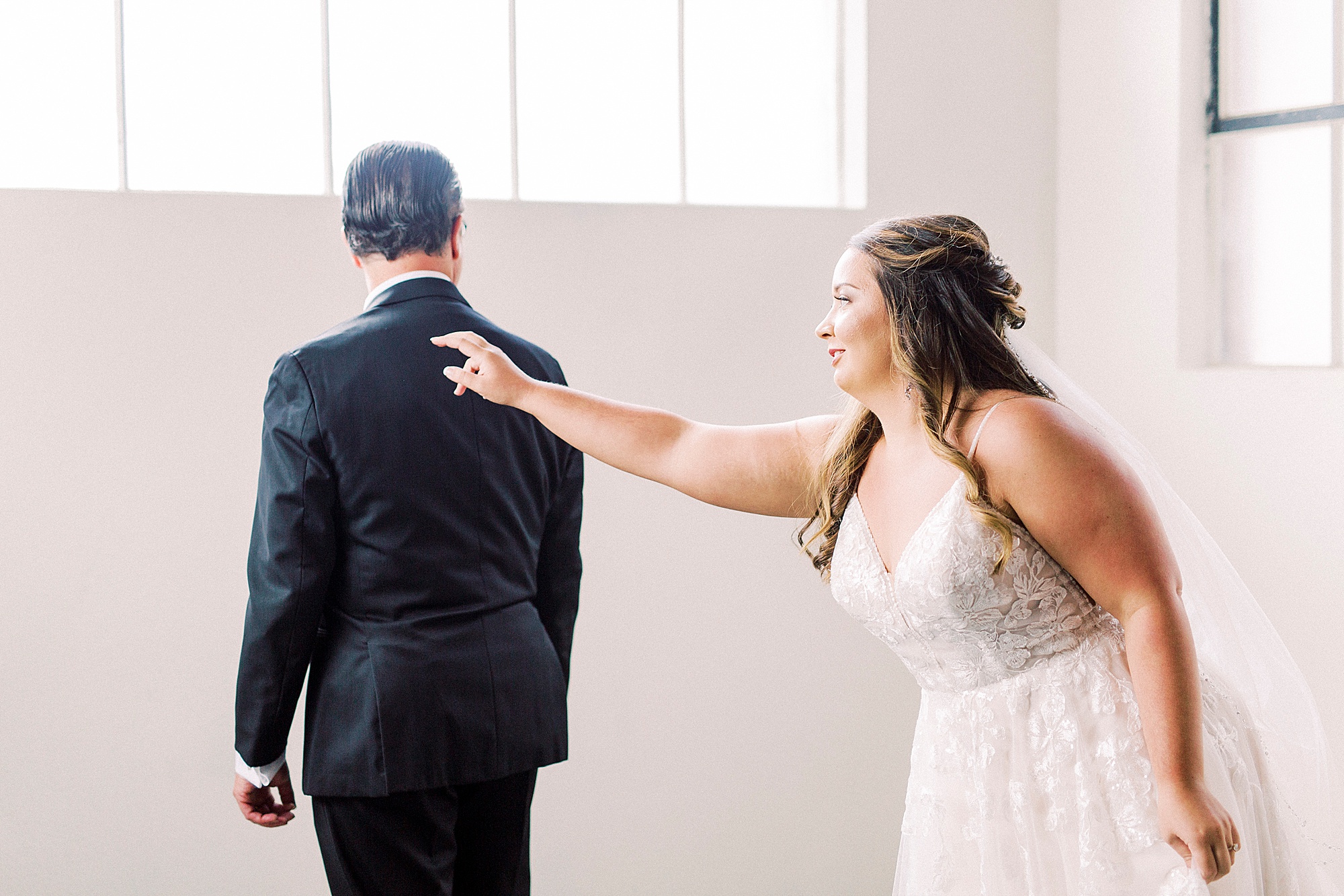 bride reaches for dad during first look