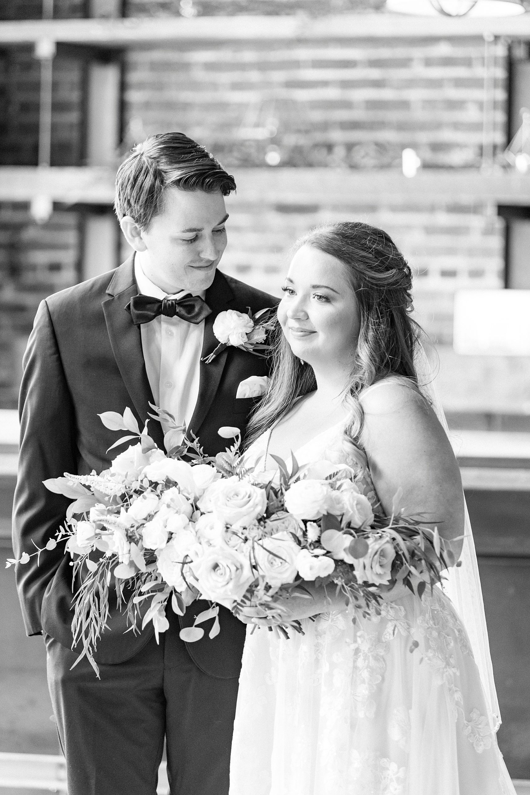 bride and groom smile together at Cadillac Service Garage