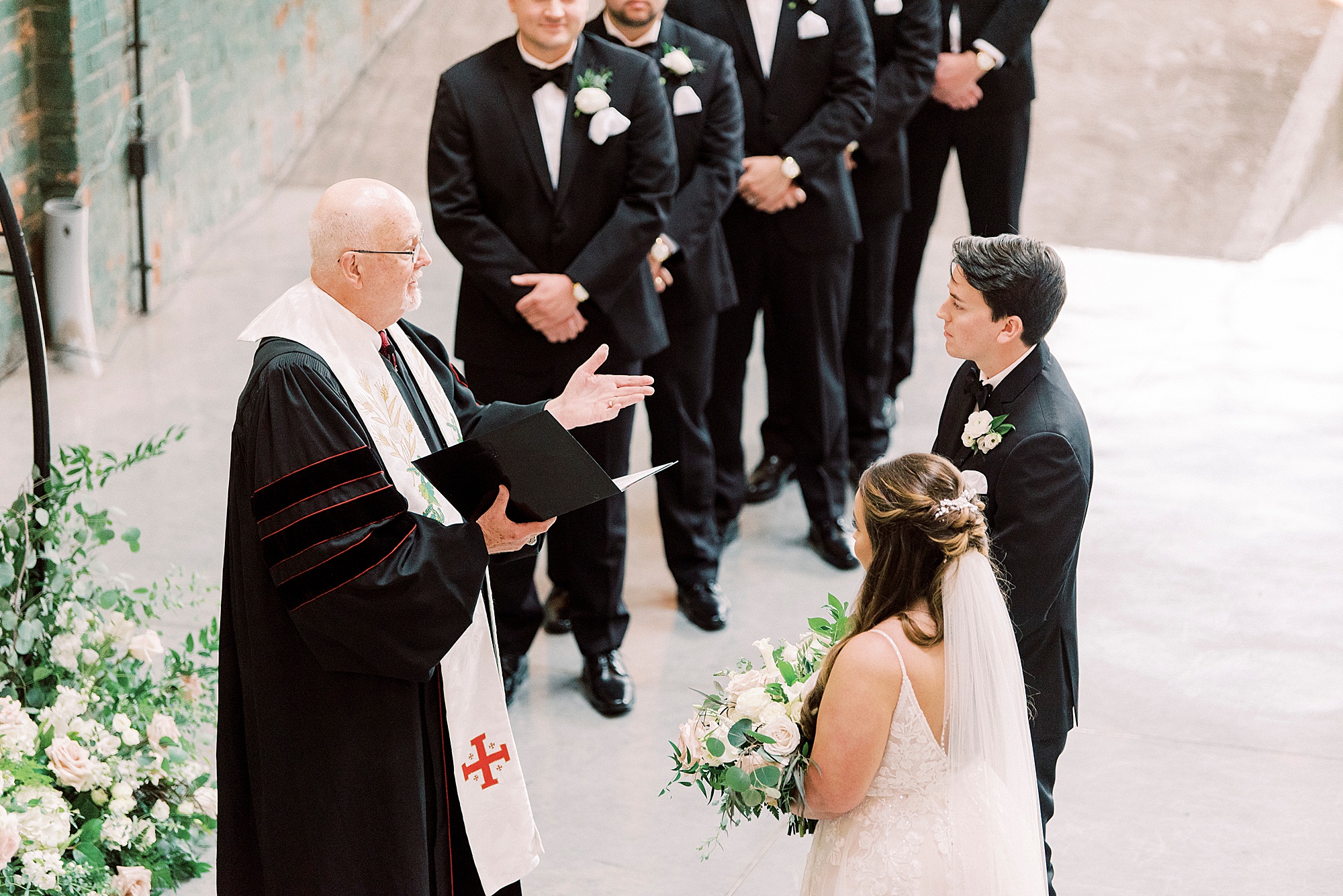 bride and groom exchange vows during Cadillac Service Garage wedding ceremony