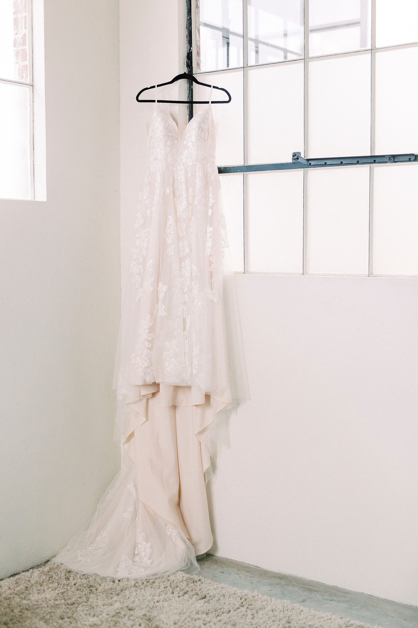 bride's dress hangs in Cadillac Service Garage